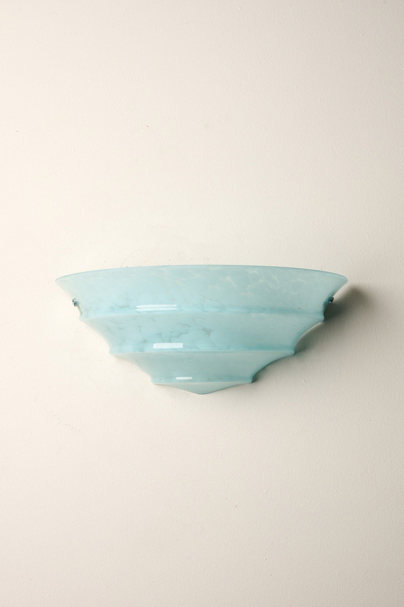 1940s Mid-Century Blue Marbled Glass Shell Wall Sconce mounted on a wall, showcasing its unique blue marbled texture.