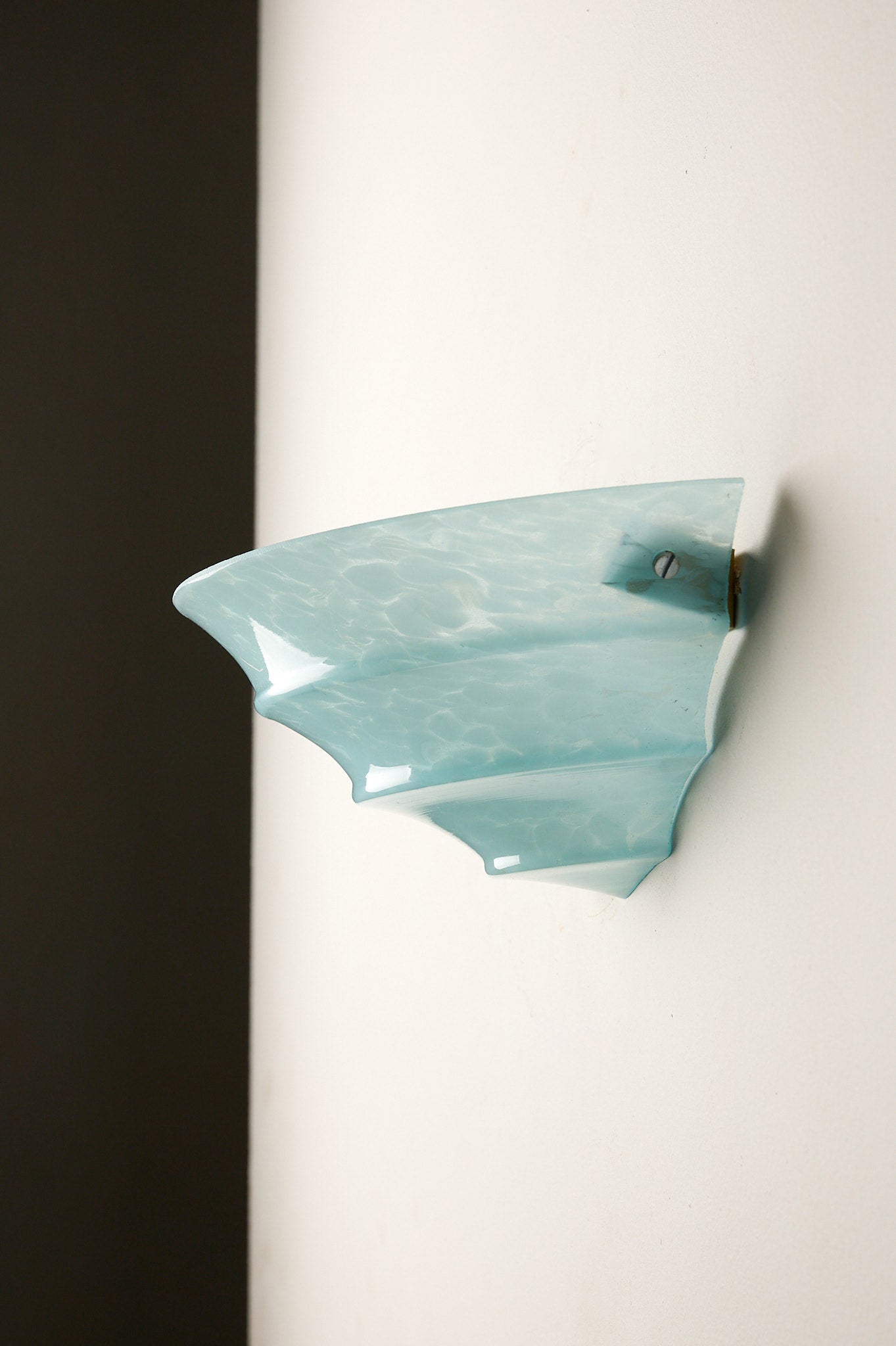 1940s Mid-Century Blue Marbled Glass Shell Wall Sconce mounted on a wall with a minimalist design.