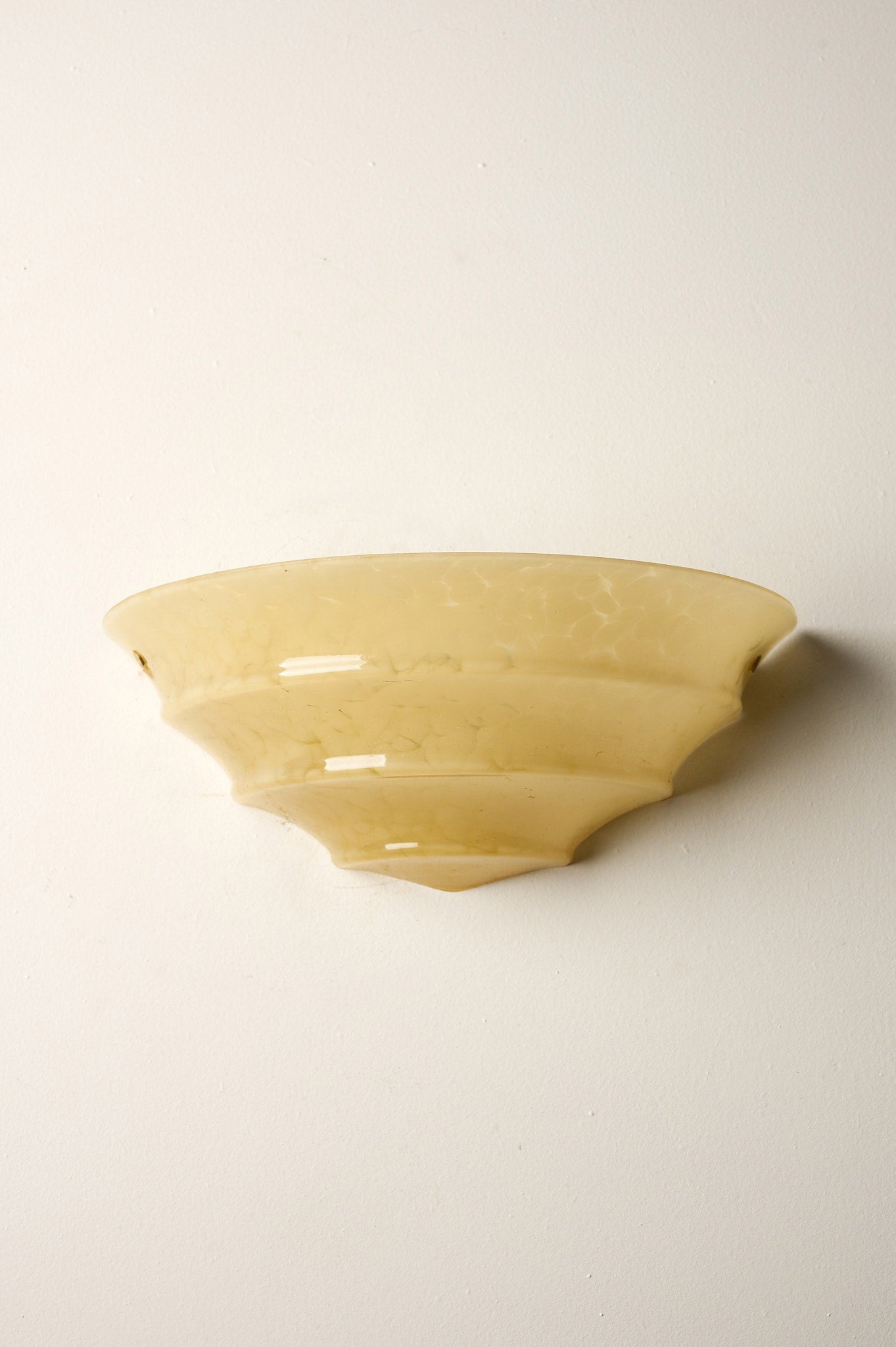 1970s Mid-Century Yellow Marbled Glass Shell Wall Sconce mounted on a white wall.