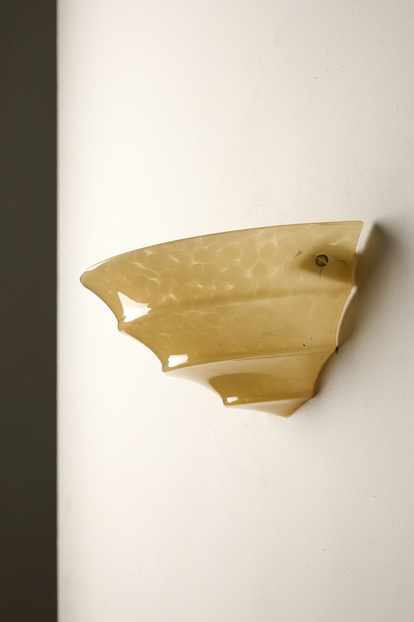 1970s Mid-Century Yellow Marbled Glass Shell Wall Sconce mounted on a wall, showcasing its elegant design.