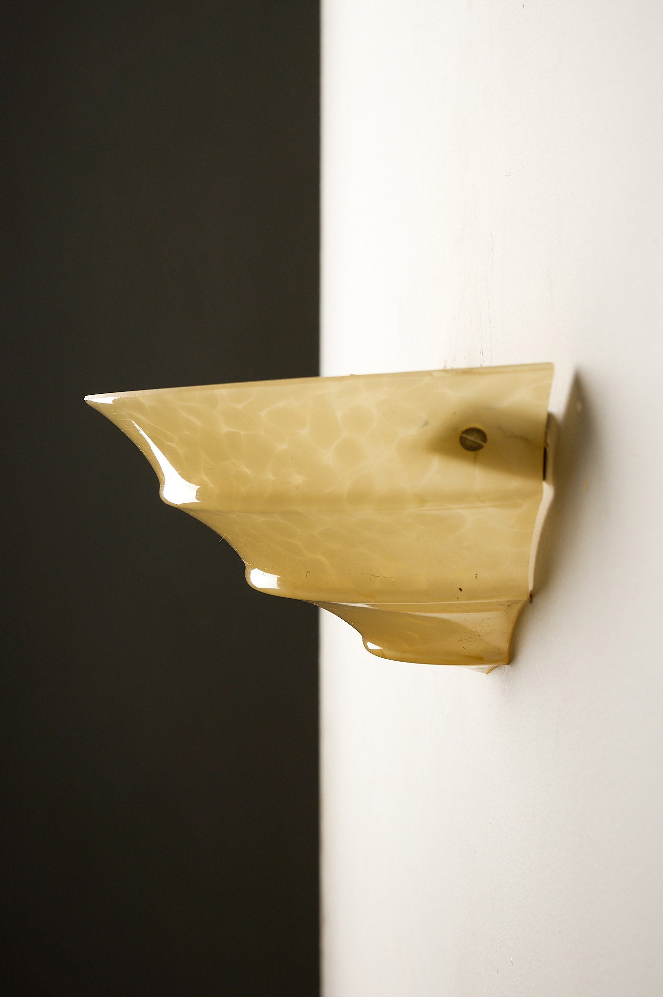 1970s Mid-Century Yellow Marbled Glass Shell Wall Sconce mounted on wall, showcasing a unique shell design.