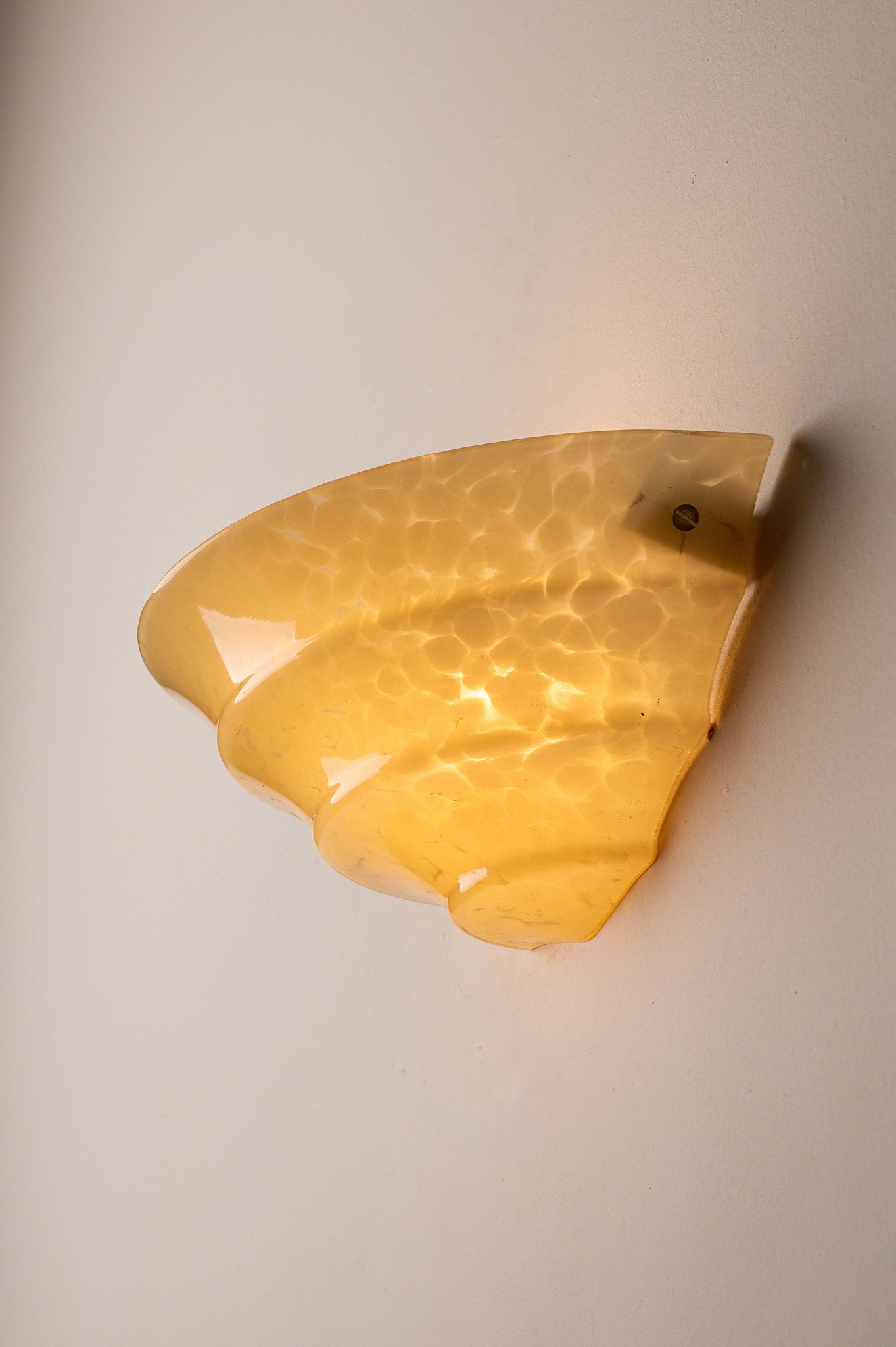 1970s Mid-Century Yellow Marbled Glass Shell Wall Sconce mounted on a wall, diffusing light elegantly.