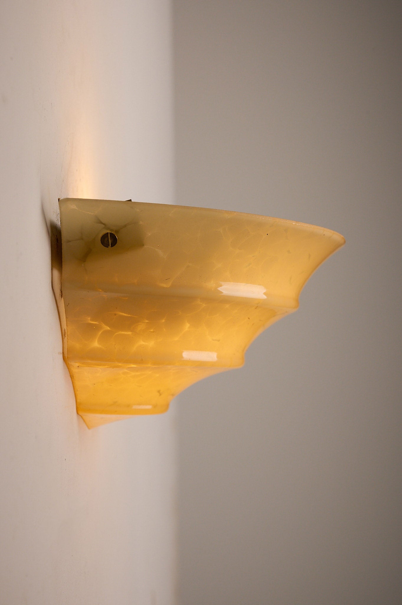 1970s Mid-Century Yellow Marbled Glass Shell Wall Sconce mounted on wall, displaying a unique shell-shaped design.