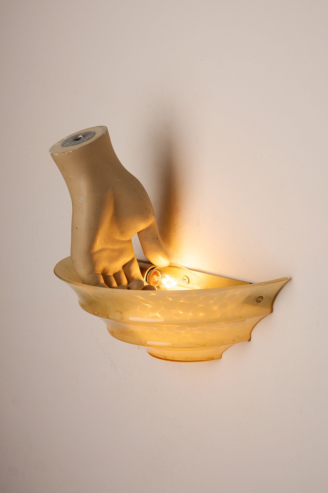 1970s Mid-Century Yellow Marbled Glass Shell Wall Sconce with hand-shaped design and soft lighting.