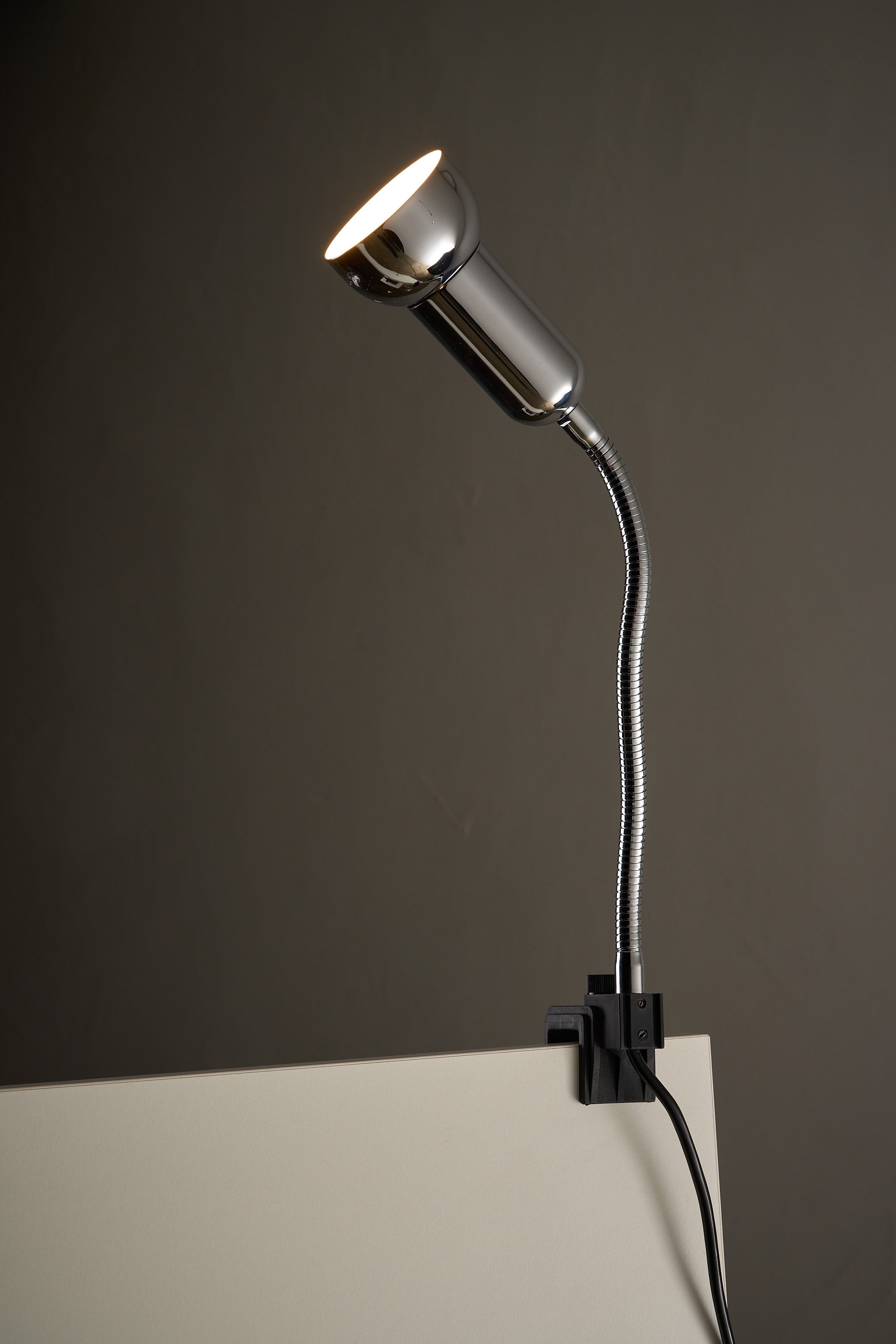 Chrome Clamp Lamp by Cosack featuring a flexible gooseneck and polished chrome shade, perfect for desks or beds.