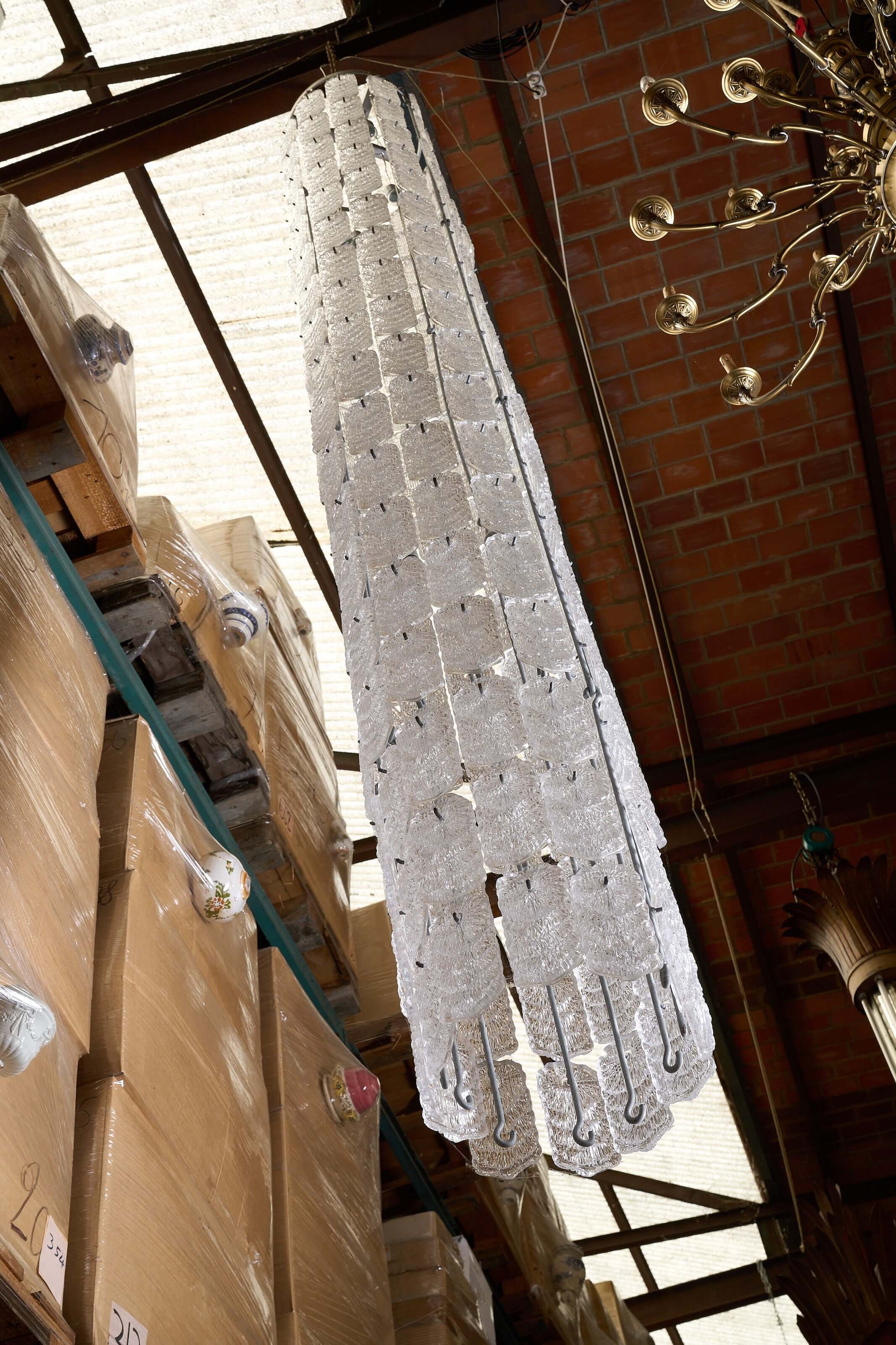XXL Glass Column Chandelier showcasing textured glass design in a warehouse setting.