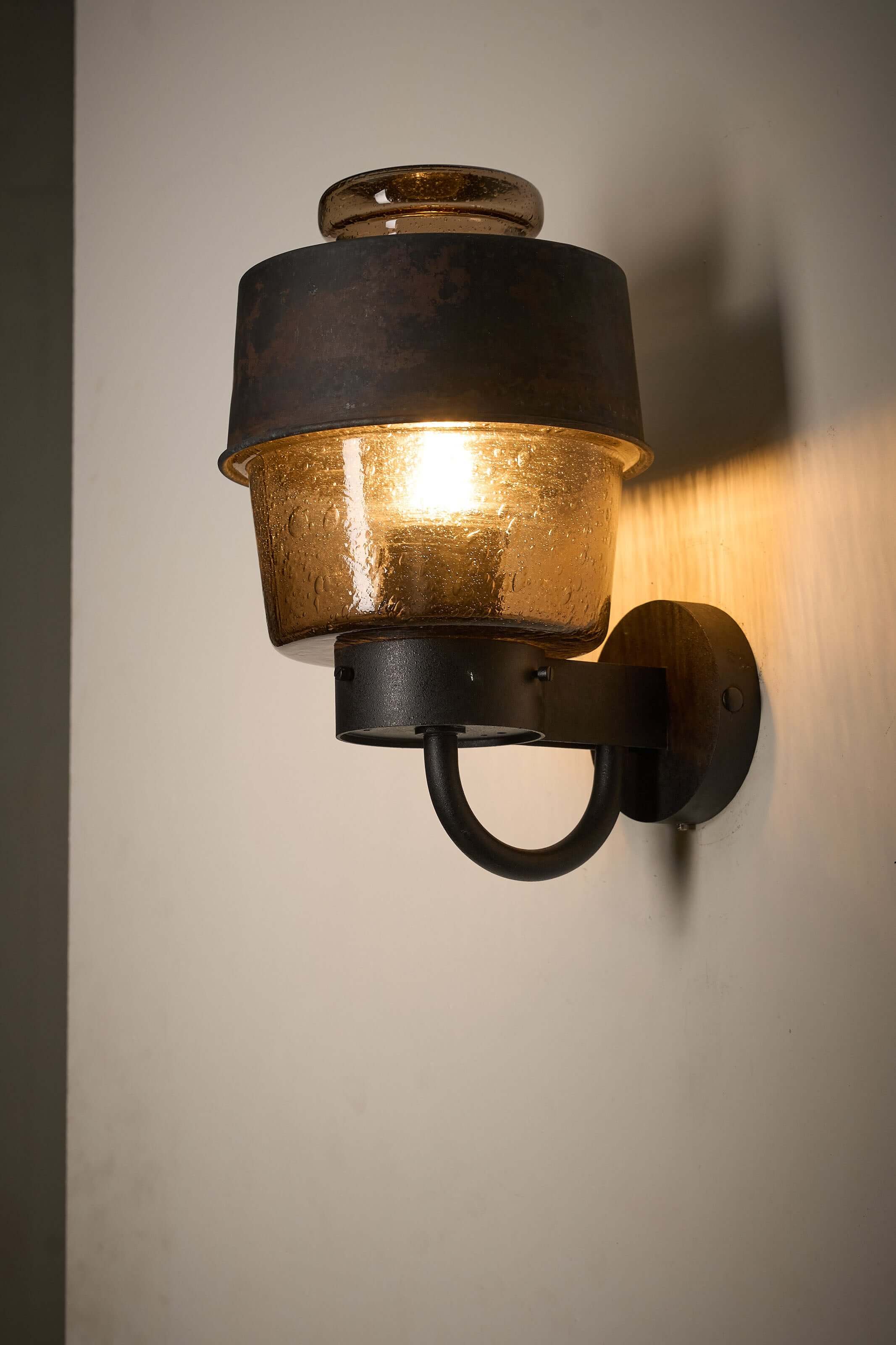 Outdoor Lantern with Amber Bubble Glass by Boom Bega mounted on a wall, showcasing its industrial design.