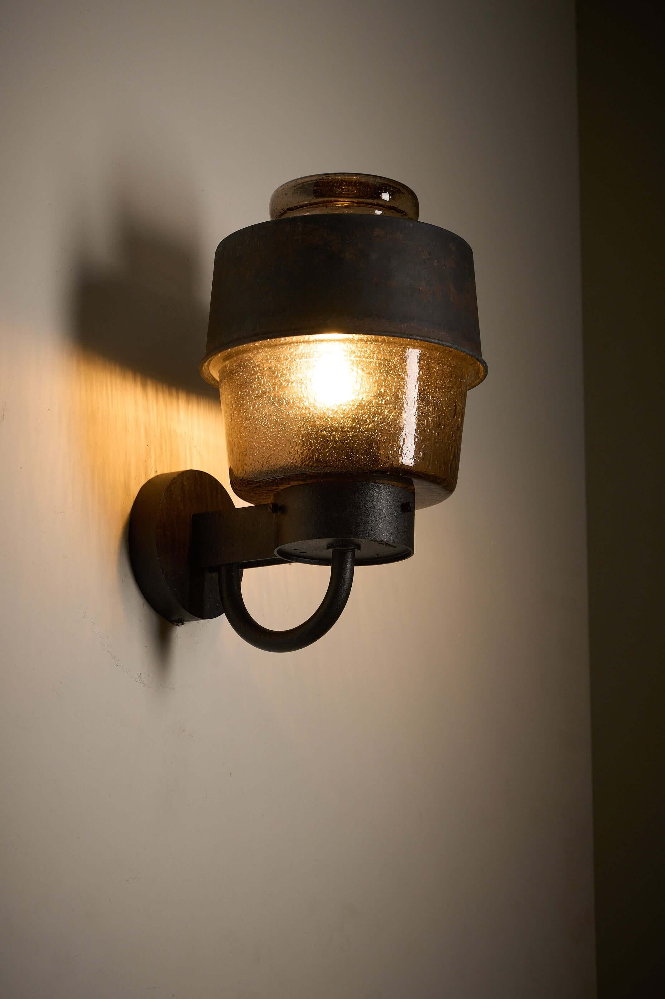 Outdoor Lantern with Amber Bubble Glass by Boom Bega mounted on a wall, showcasing its industrial design.