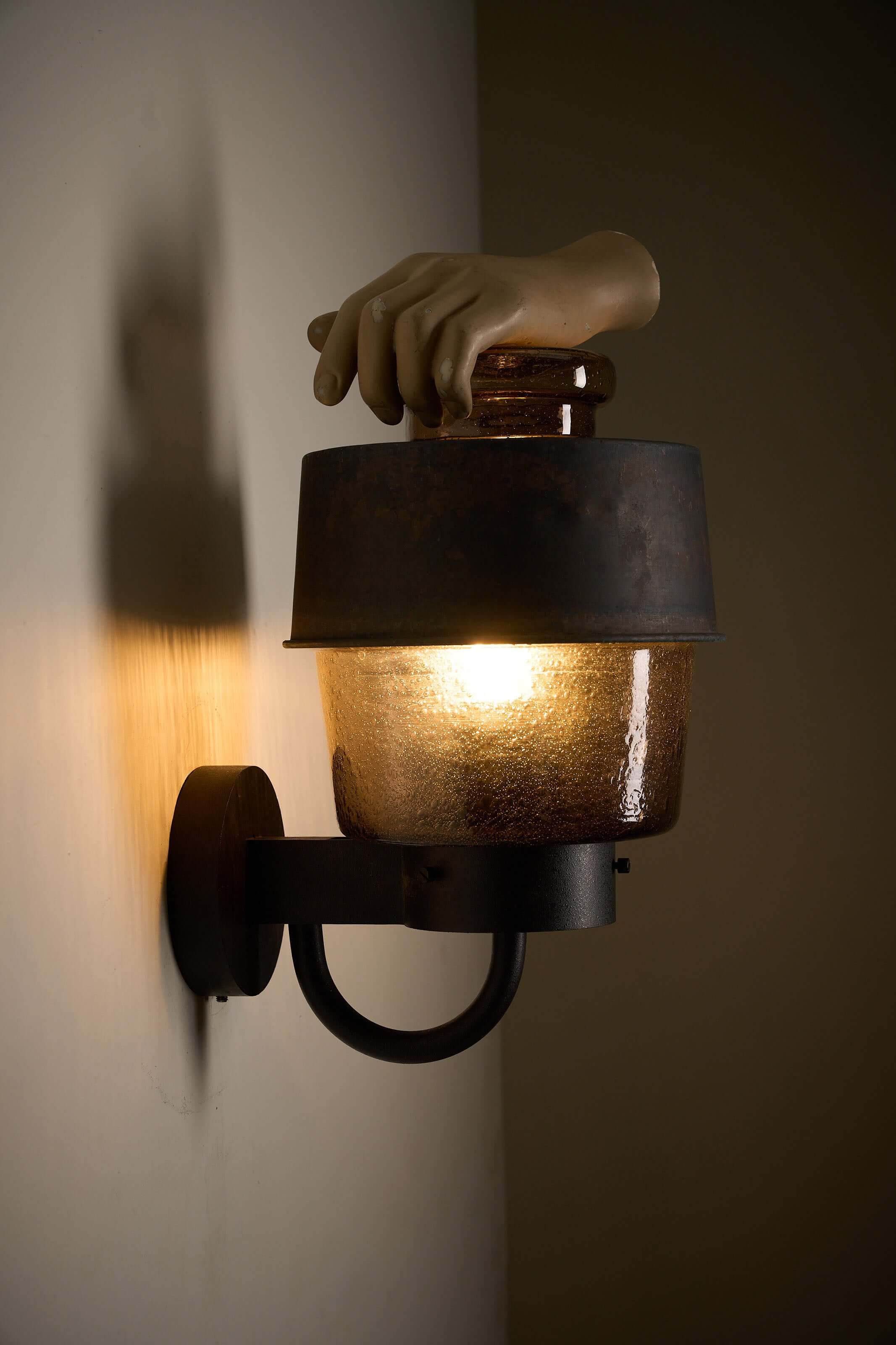 Outdoor Lantern with Amber Bubble Glass by Boom Bega mounted on a wall, featuring a hand and industrial design.
