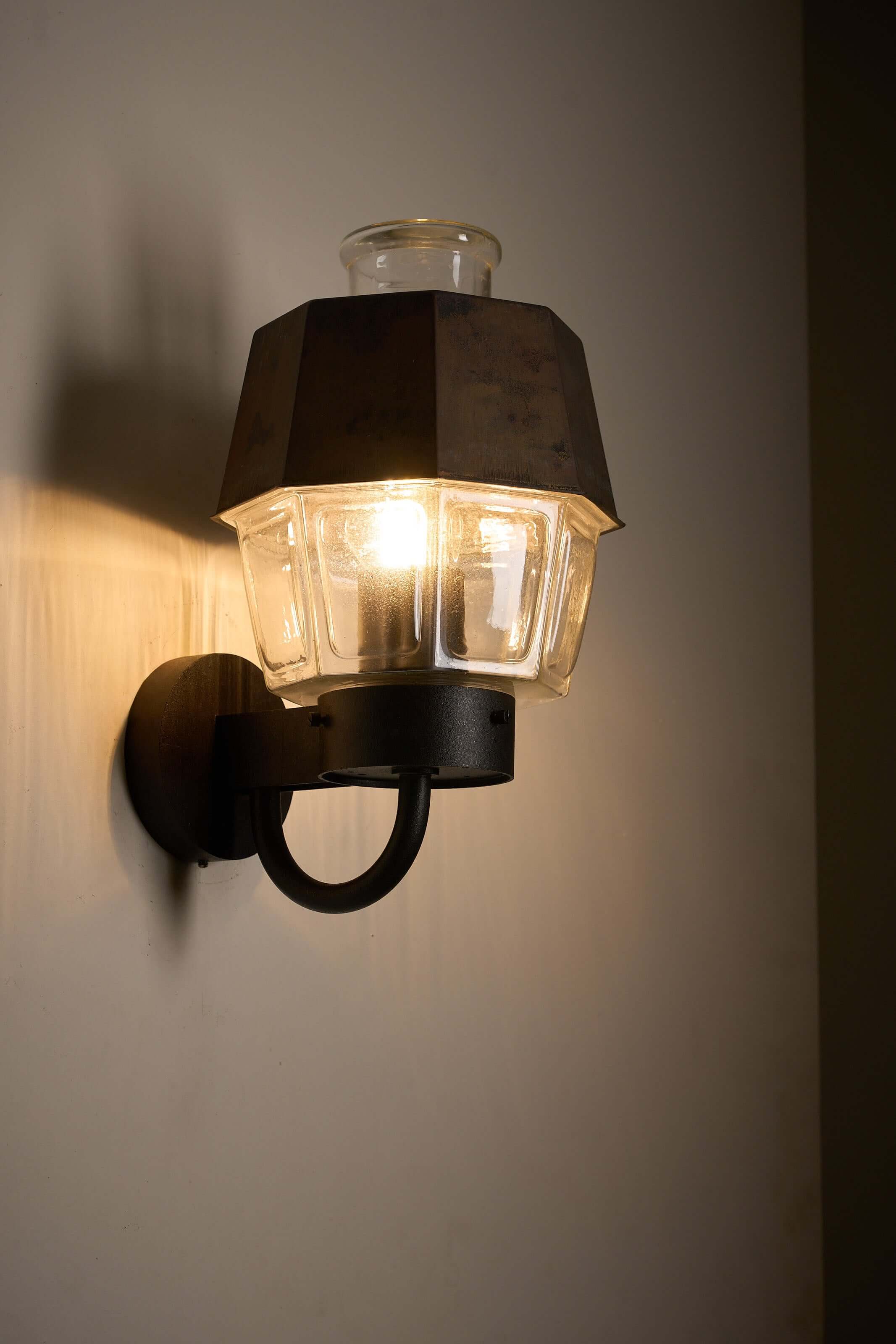 Outdoor Lantern Wall Lamp with Copper Reflector by Boom Bega mounted on wall, showcasing pressed glass and copper details.