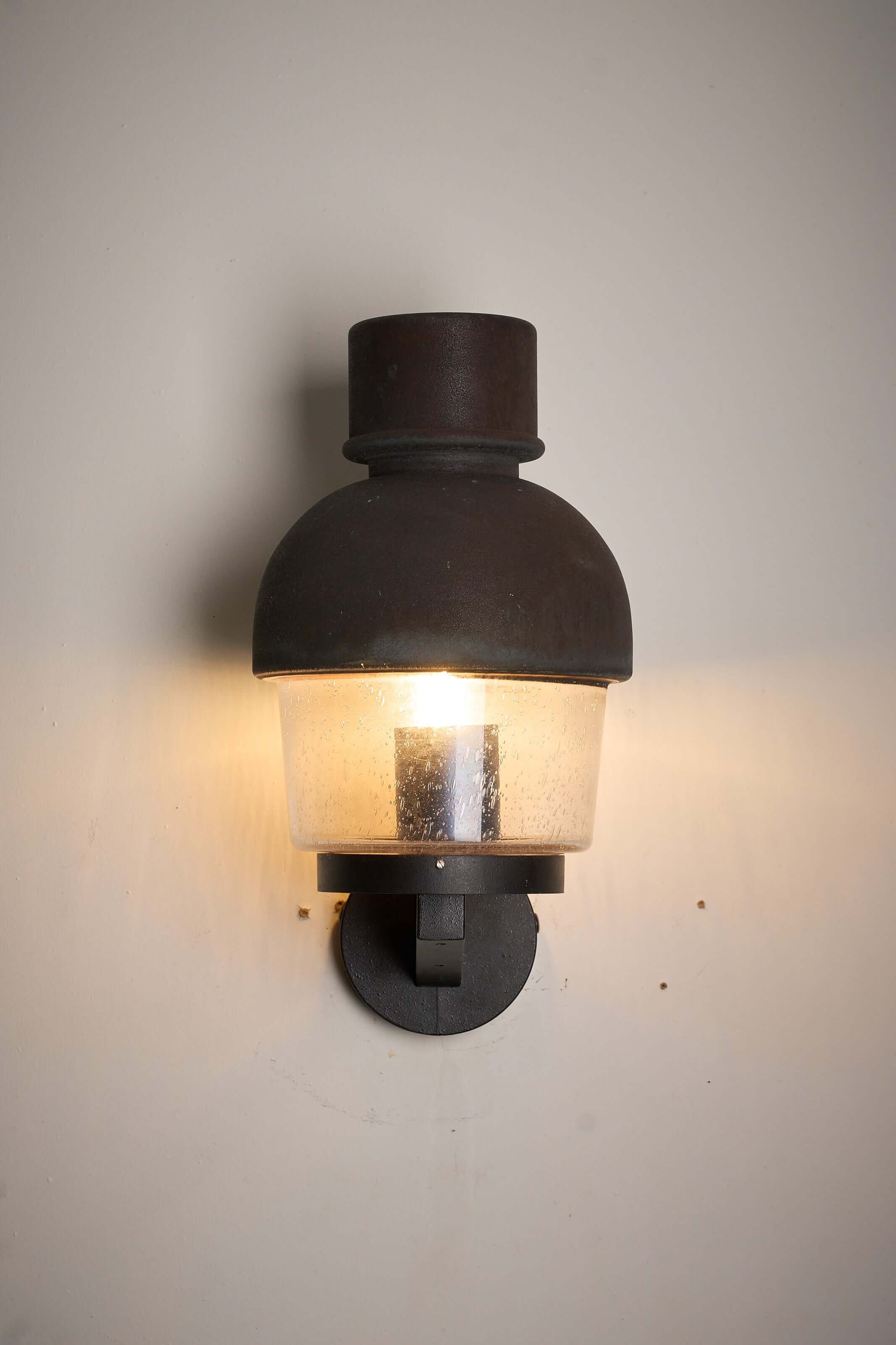 'Boom' Wall Lamp with Fused Copper Alloy on Glass, a vintage style outdoor lantern with warm lighting.