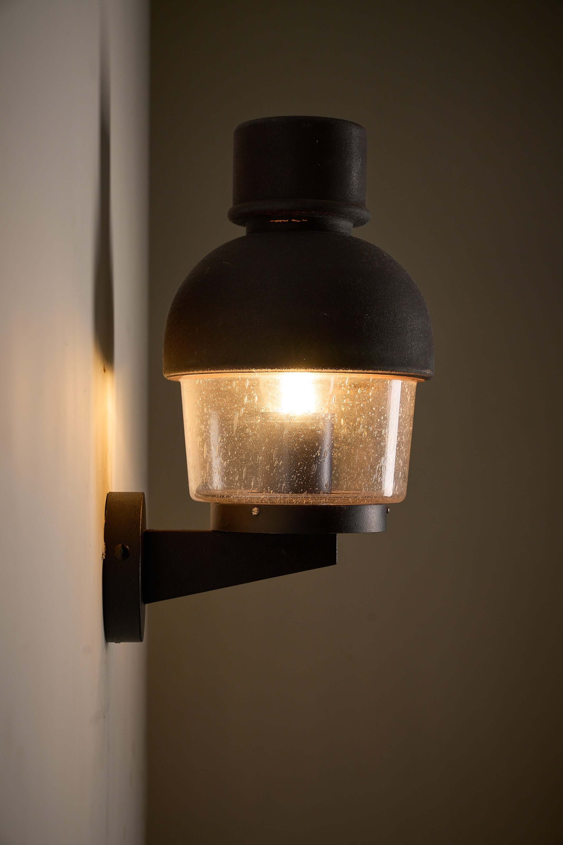 'Boom' Wall Lamp with Fused Copper Alloy on Glass, outdoor lantern with warm ambient glow.