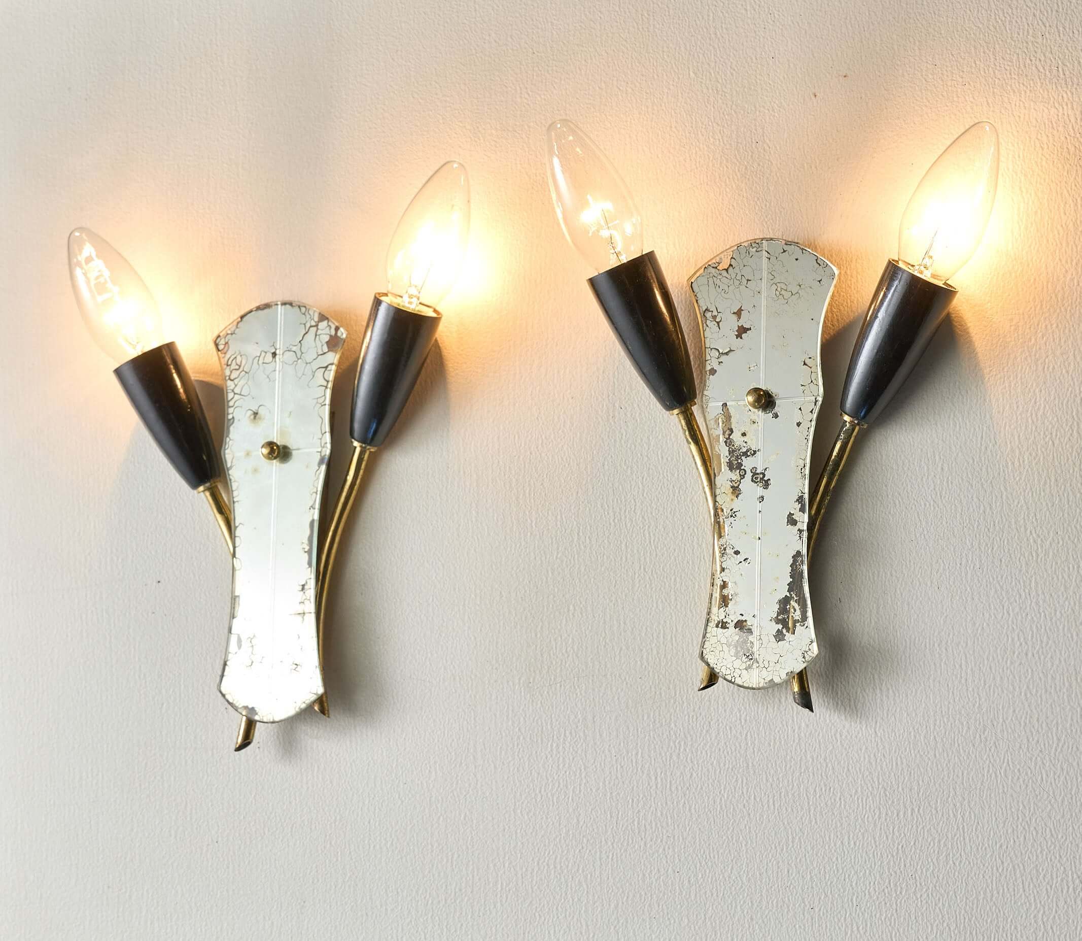 Brass and Mirrored Glass Wall Lamp, 1950s with three bulb holders and vintage design, illuminating a wall.