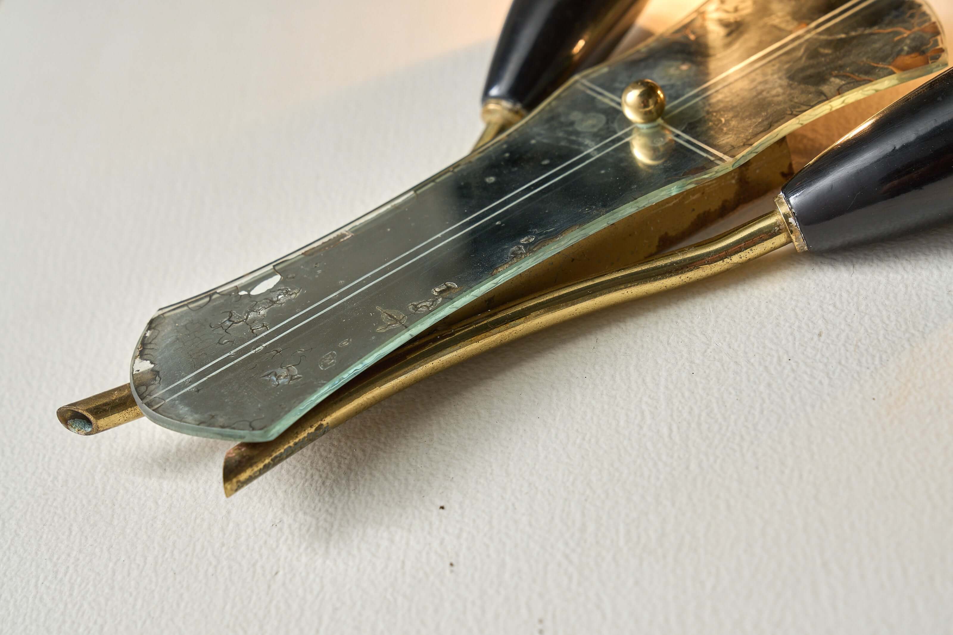 Brass and Mirrored Glass Wall Lamp, 1950s with curved brass tubes and etched mirror detail.
