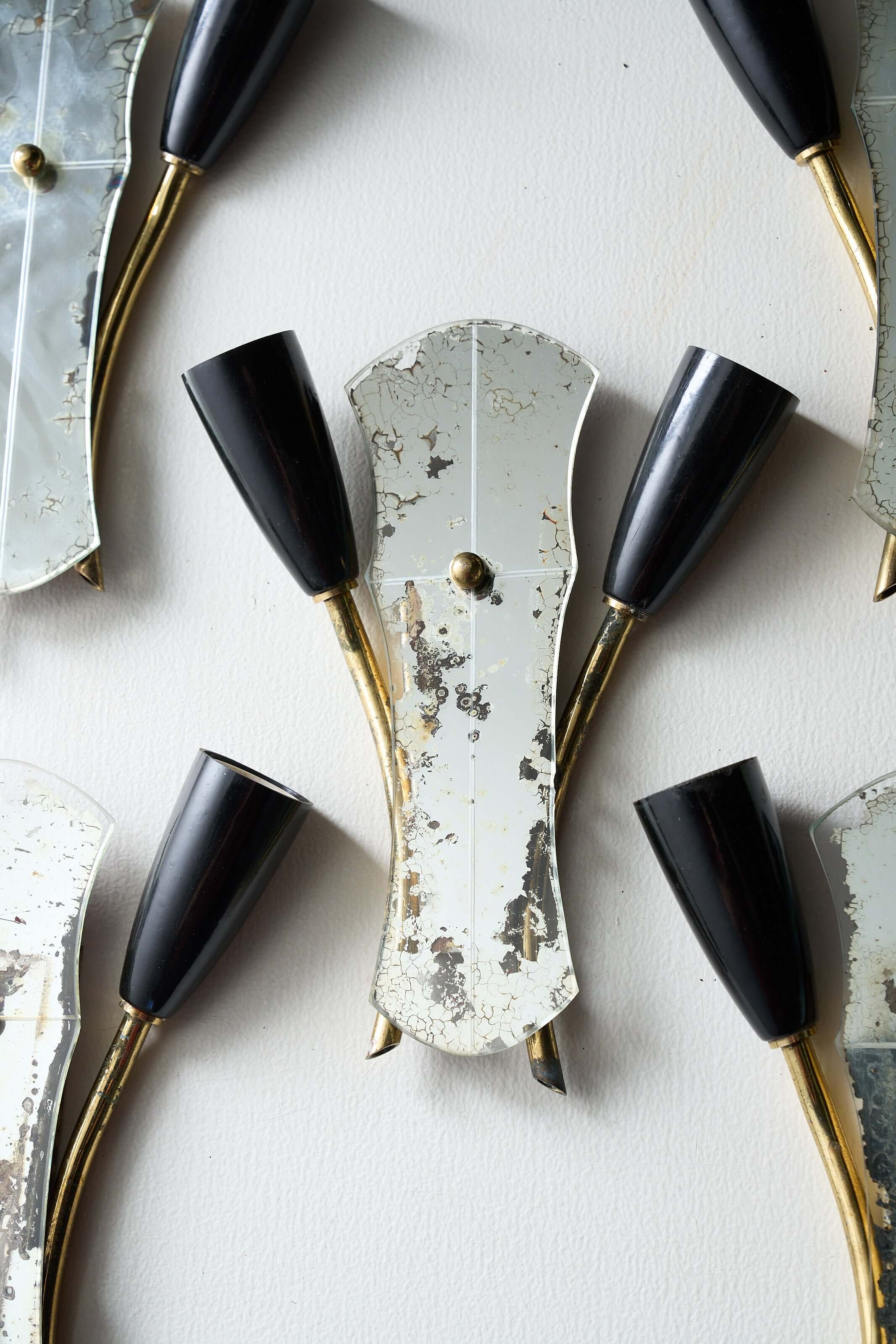 Brass and Mirrored Glass Wall Lamp, 1950s with asymmetrical curved design and black lampholders.
