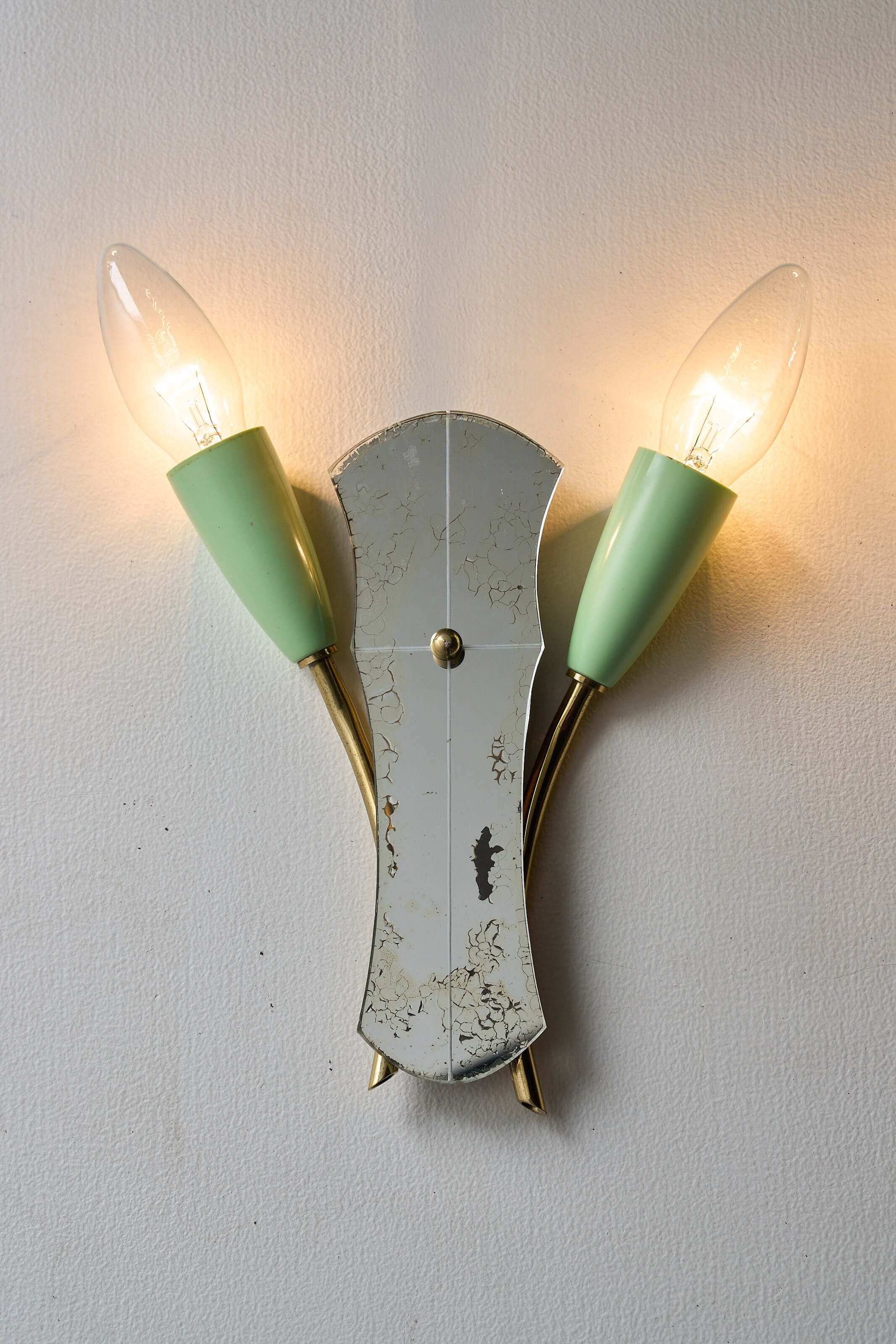 Brass and Mirrored Glass Wall Lamp, 1950s featuring pale green lampholders and shaped mirror.