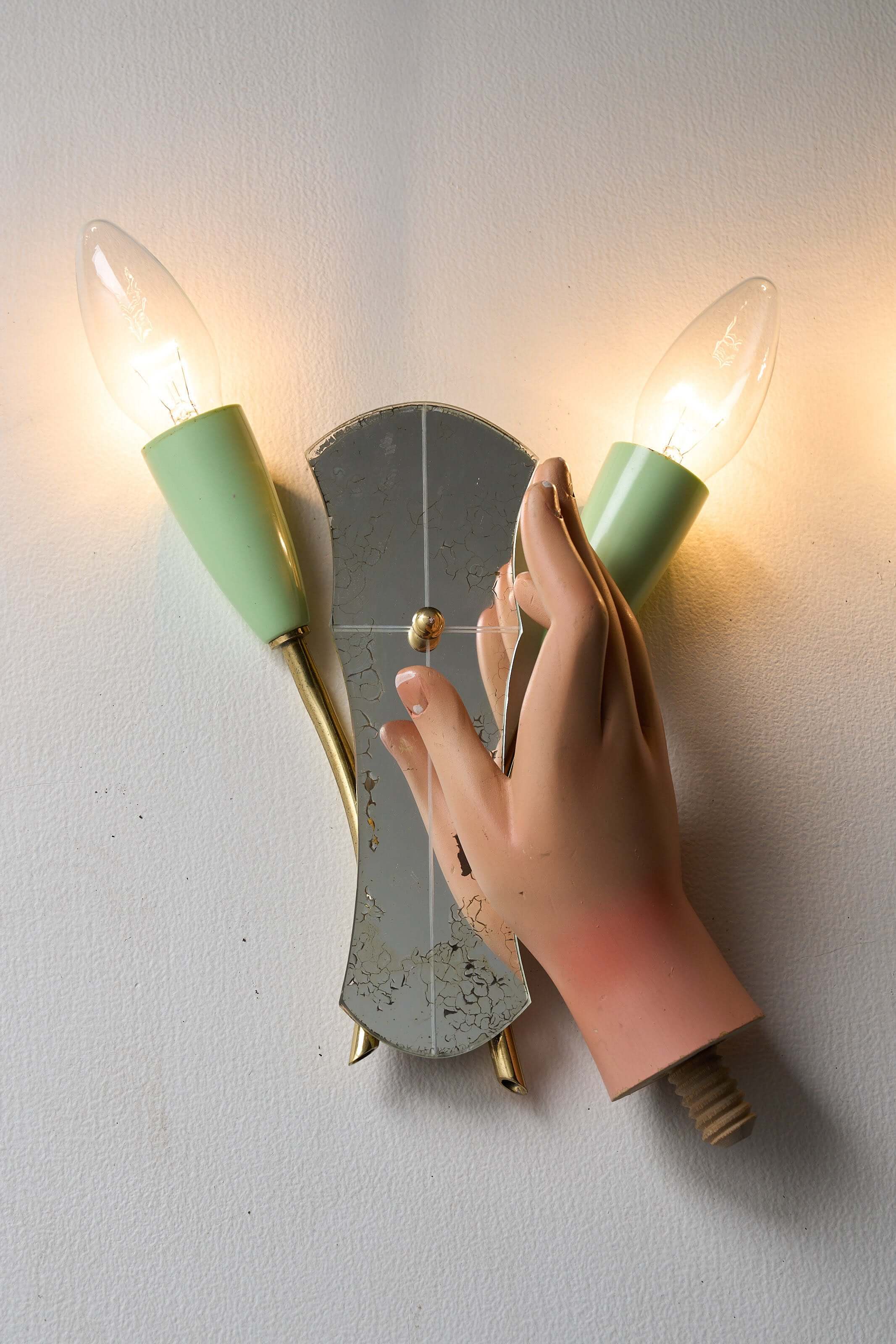 Brass and Mirrored Glass Wall Lamp, 1950s displaying unique hand design and pale green cone-shaped lampholders.
