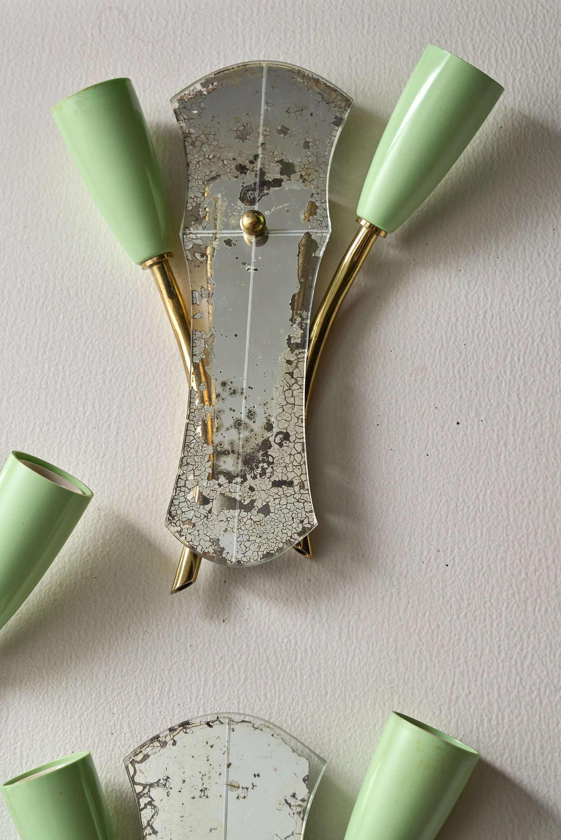 Brass and Mirrored Glass Wall Lamp, 1950s featuring a cracked mirror and pale green lampholders.