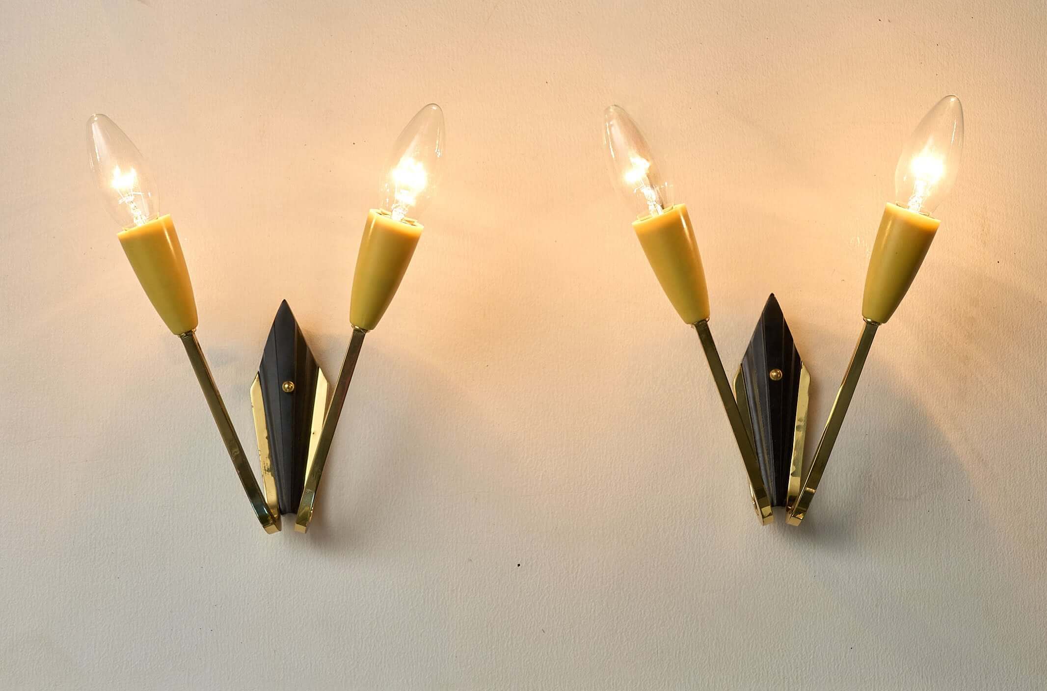 Geometric Brass and Black Wall Lamp, 1950s featuring vintage design with yellow light sockets.