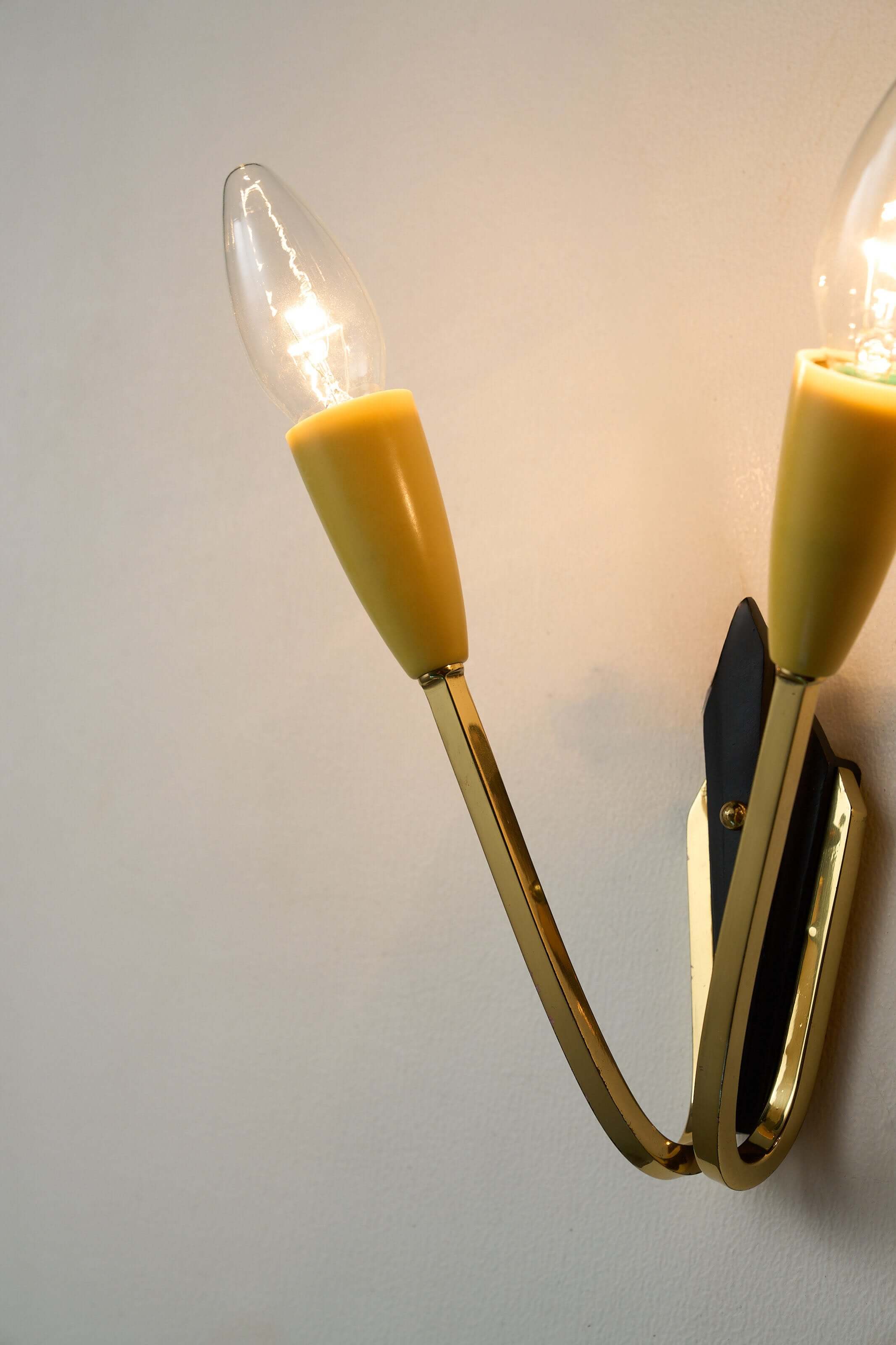 Geometric Brass and Black Wall Lamp, 1950s with cone-shaped light sockets and black base, mid-century vintage style.