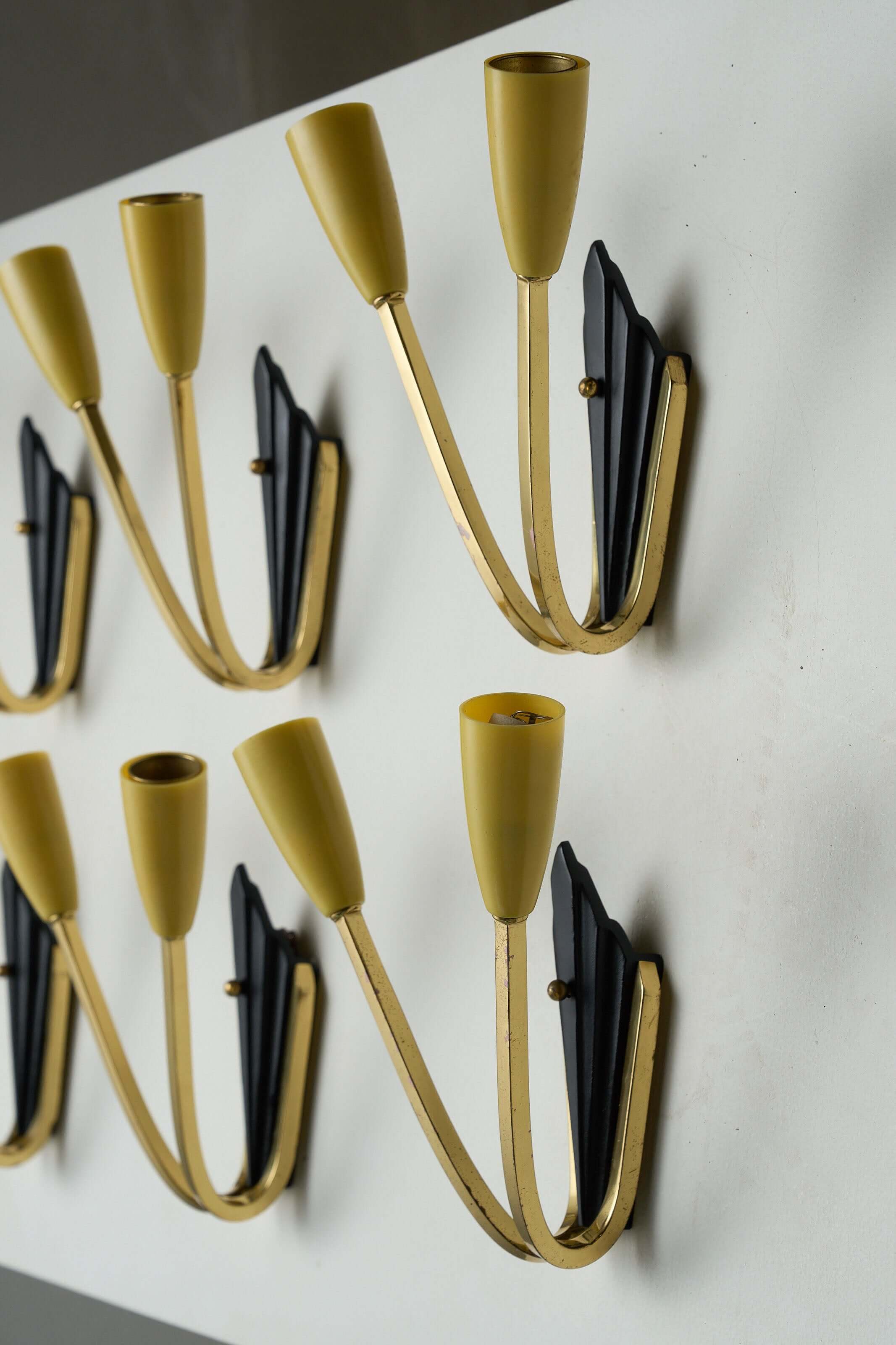 Geometric Brass and Black Wall Lamp, 1950s with yellow cone-shaped light sockets and sleek design.