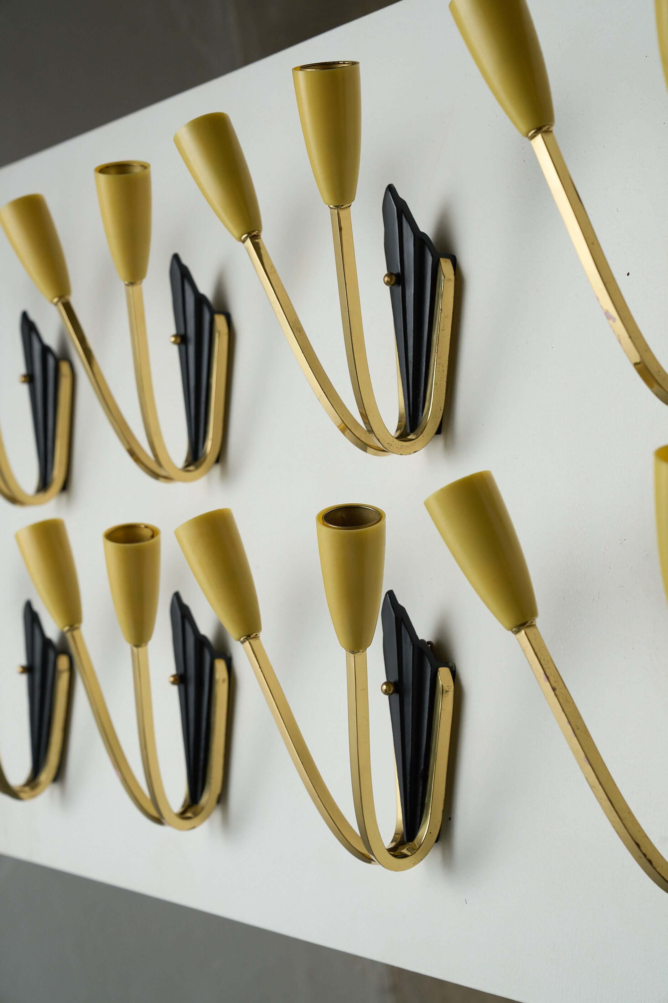 Geometric Brass and Black Wall Lamp, 1950s with pastel yellow cone-shaped light sockets and a black diamond-like base.