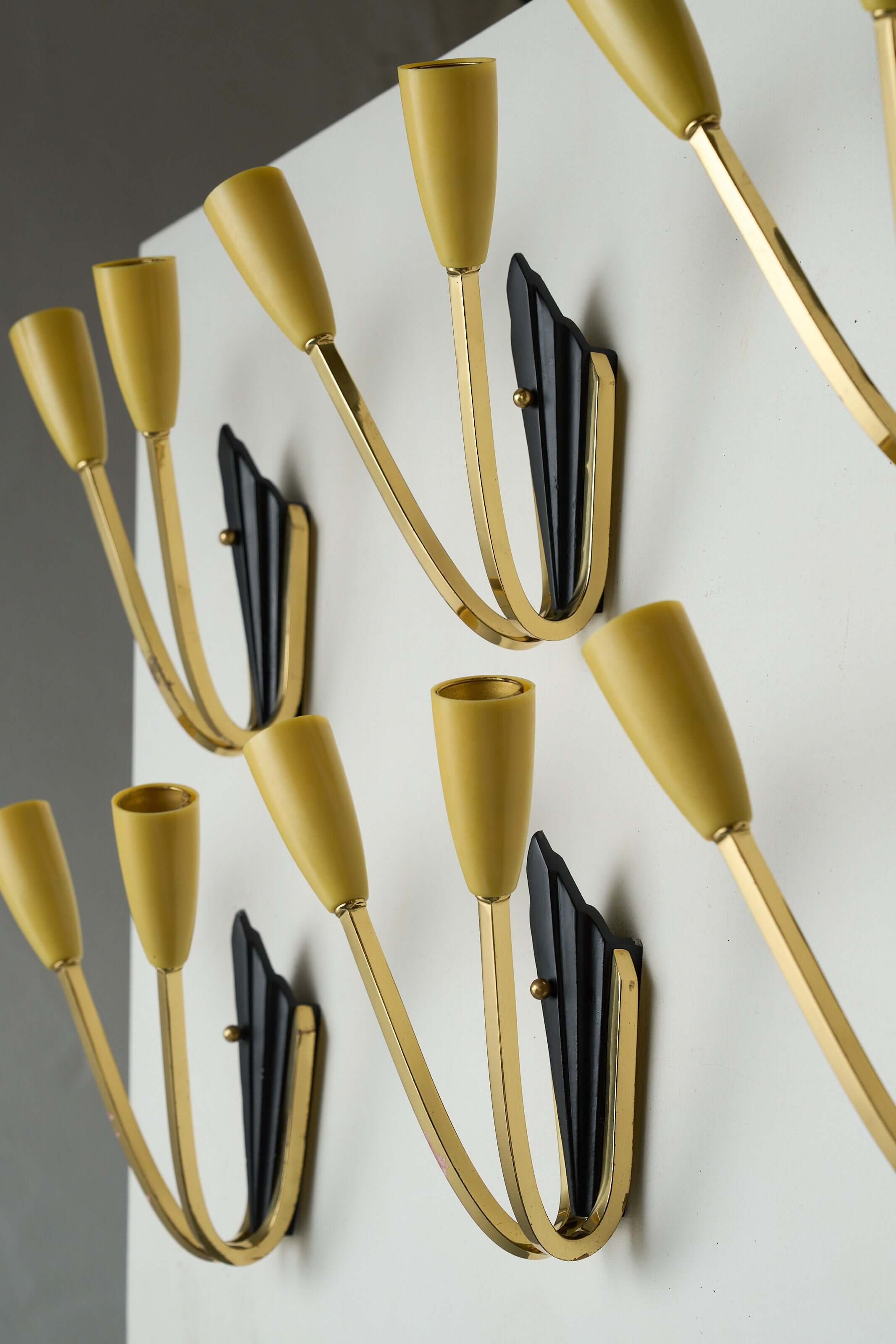 Geometric Brass and Black Wall Lamp, 1950s with yellow light sockets and black base on wall