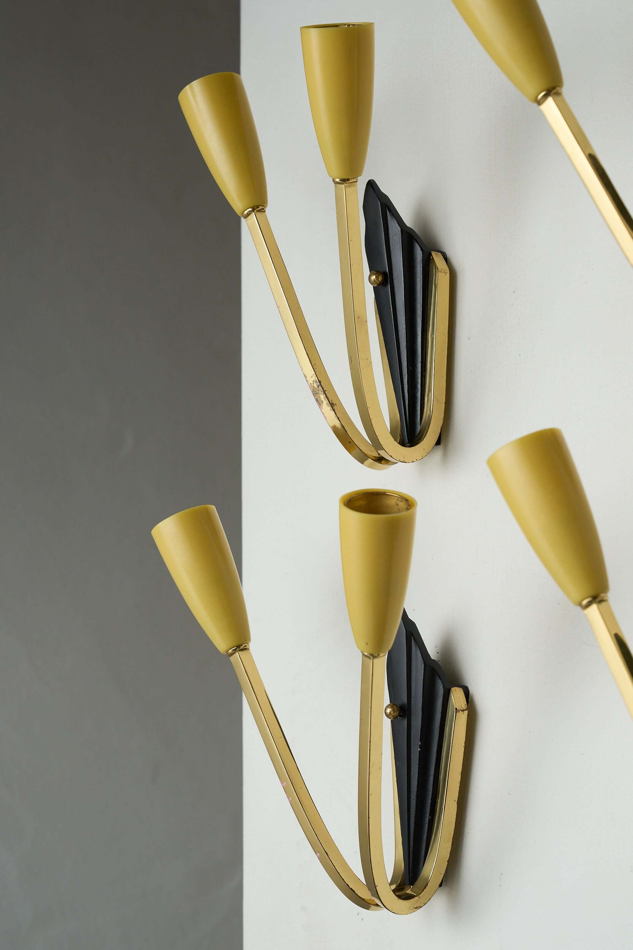 Geometric Brass and Black Wall Lamp, 1950s with yellow light sockets and black wall base, mid-century vintage design.