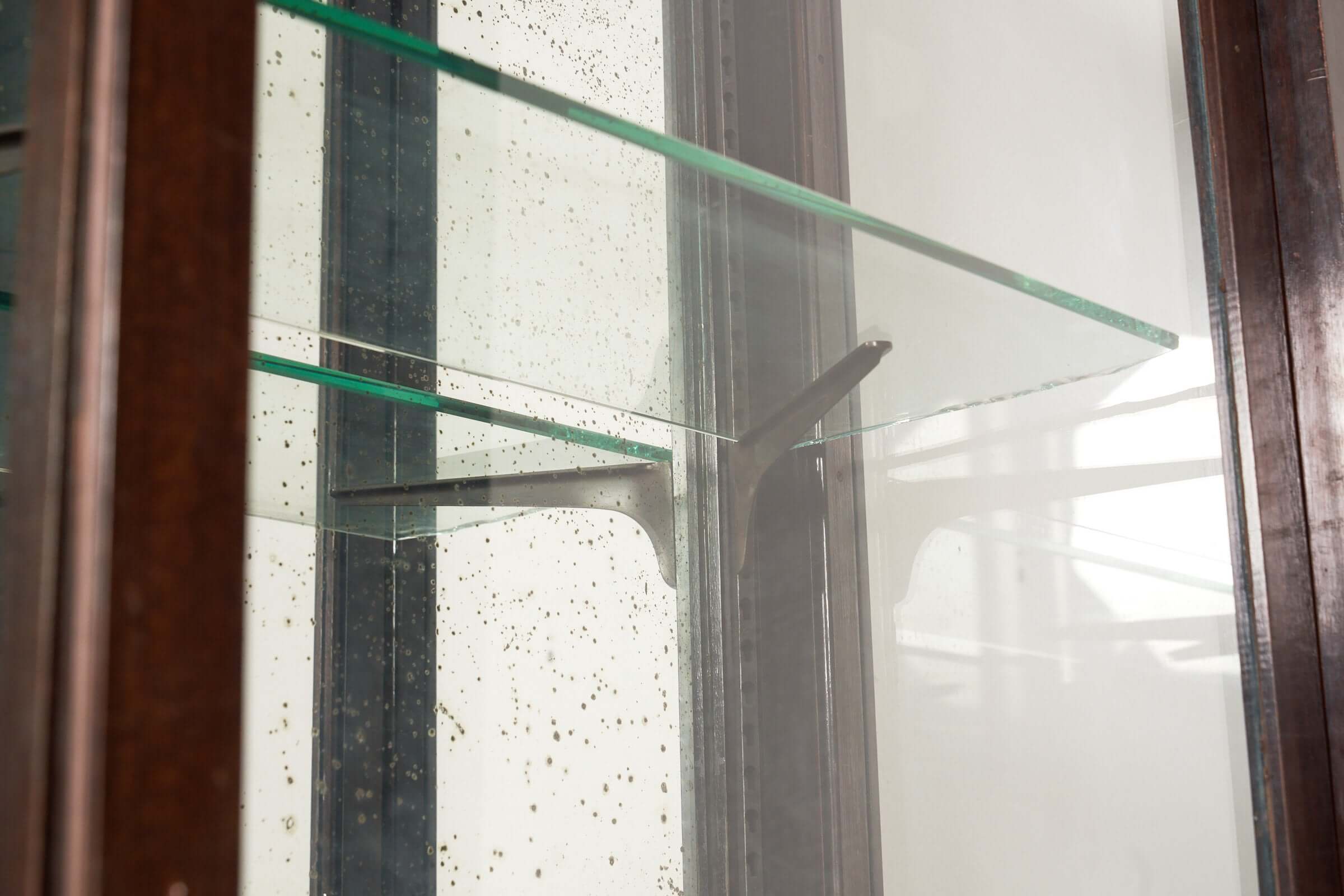Art Deco Mirrored Display Cabinet with Sliding Doors interior featuring adjustable glass shelves.