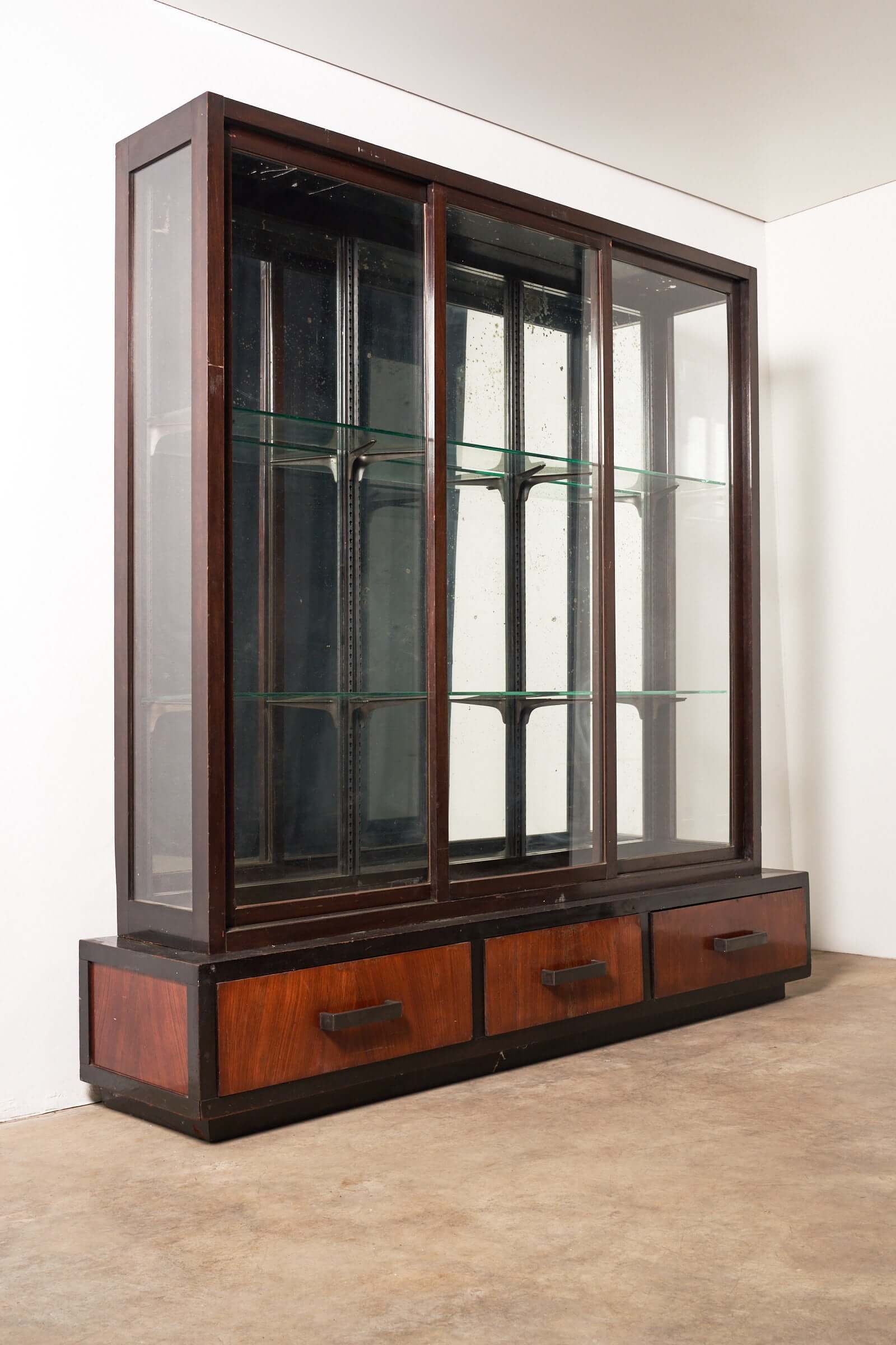 Art Deco Mirrored Display Cabinet with Sliding Doors showcasing glass shelves and wooden drawers.
