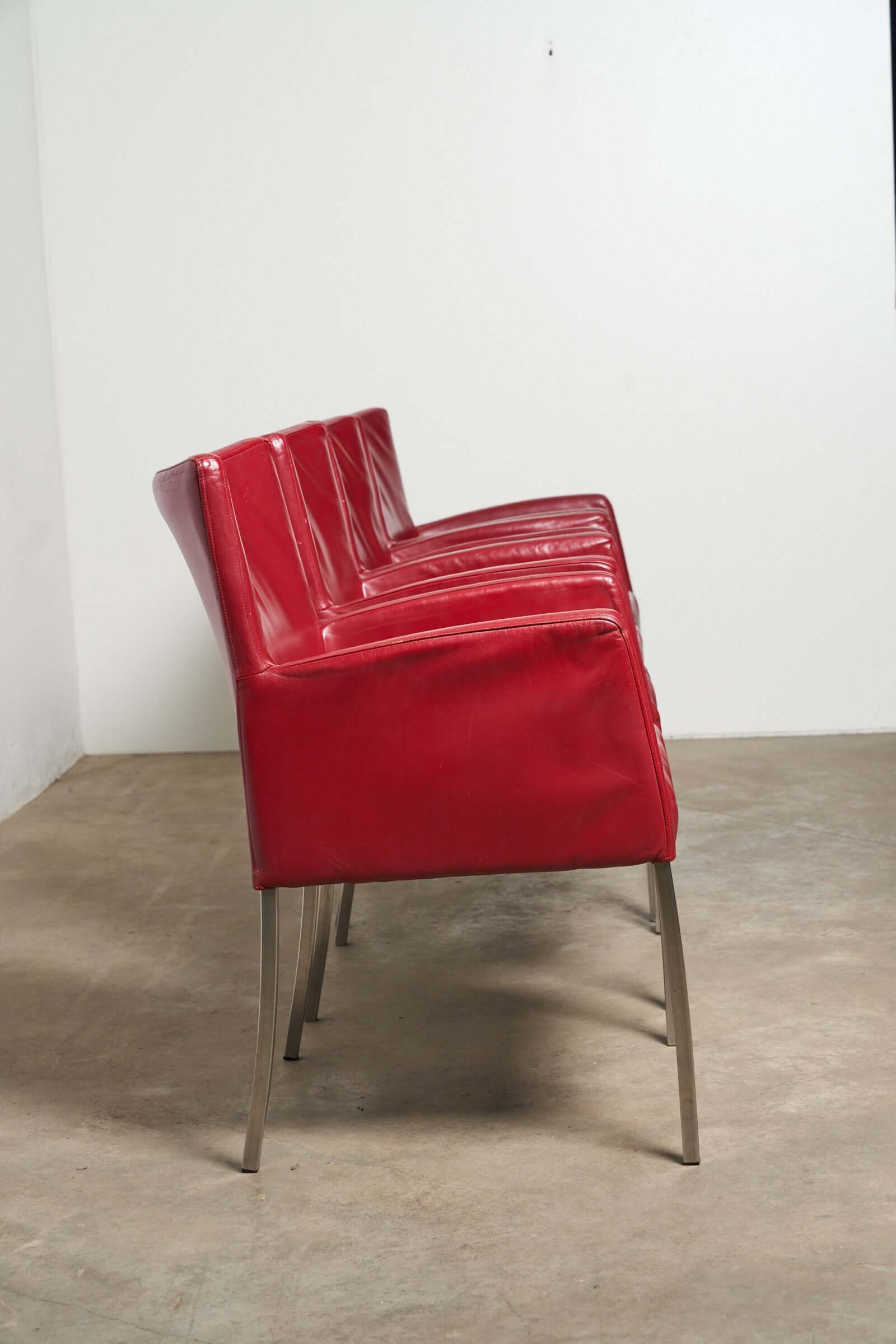 Red or Black Leather Armchairs in bold red leather with sleek metal legs, ideal for dining or creative spaces.