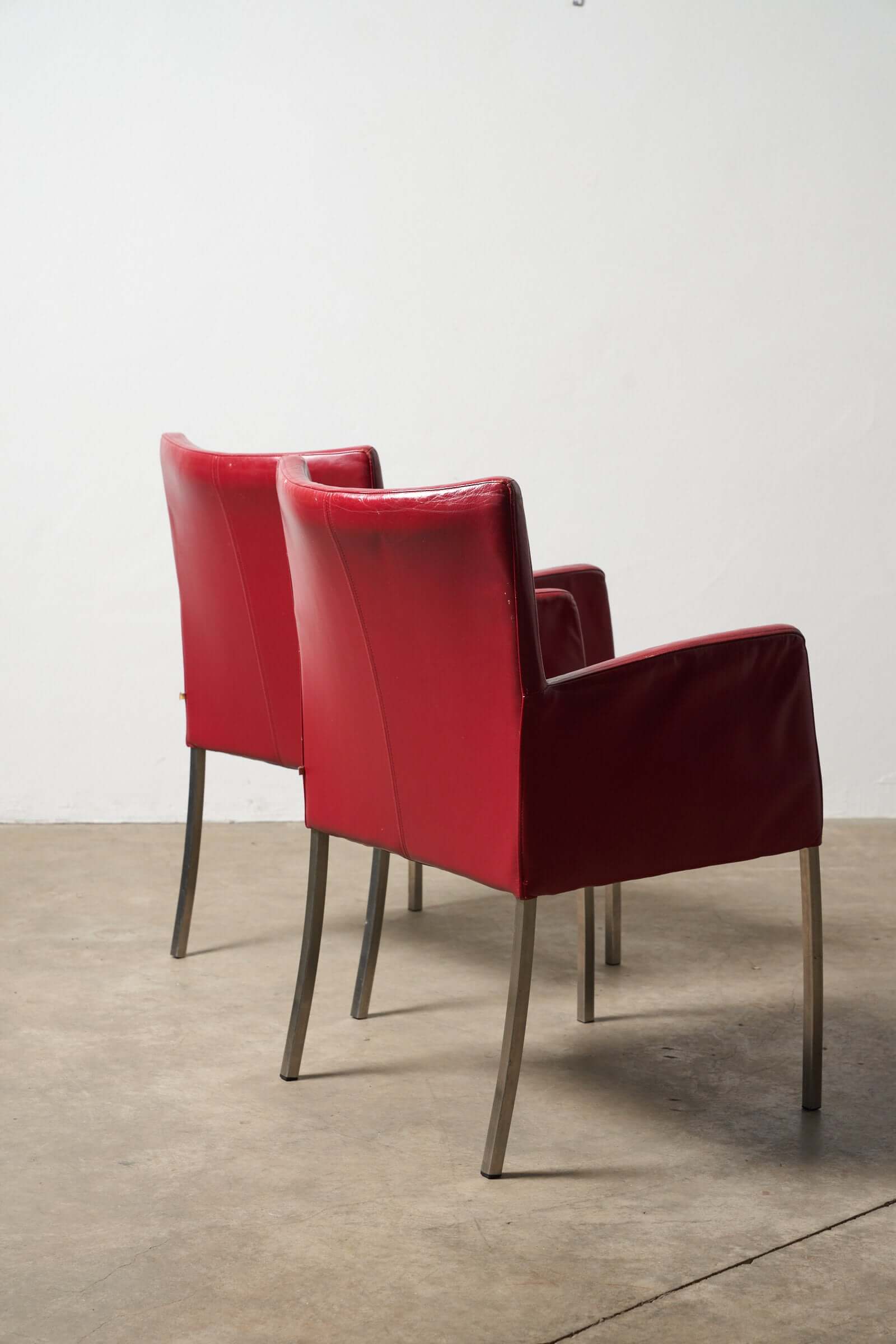 Red or Black Leather Armchairs showcasing vibrant red accent chairs with sleek metal legs.