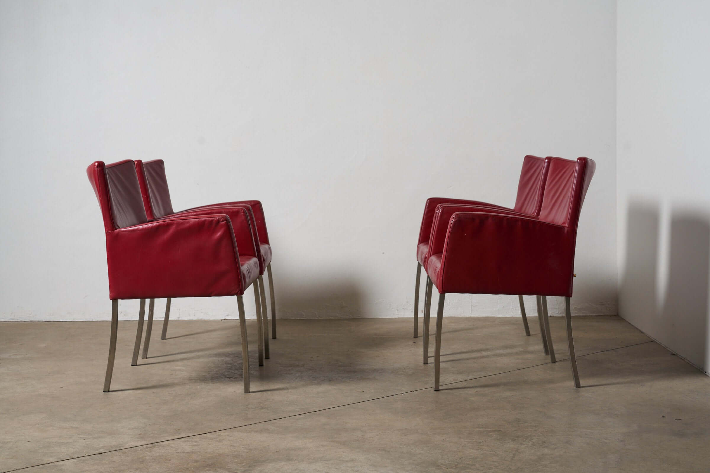 Red or Black Leather Armchairs in vibrant red leather, showcasing Italian design for a dining room or studio.