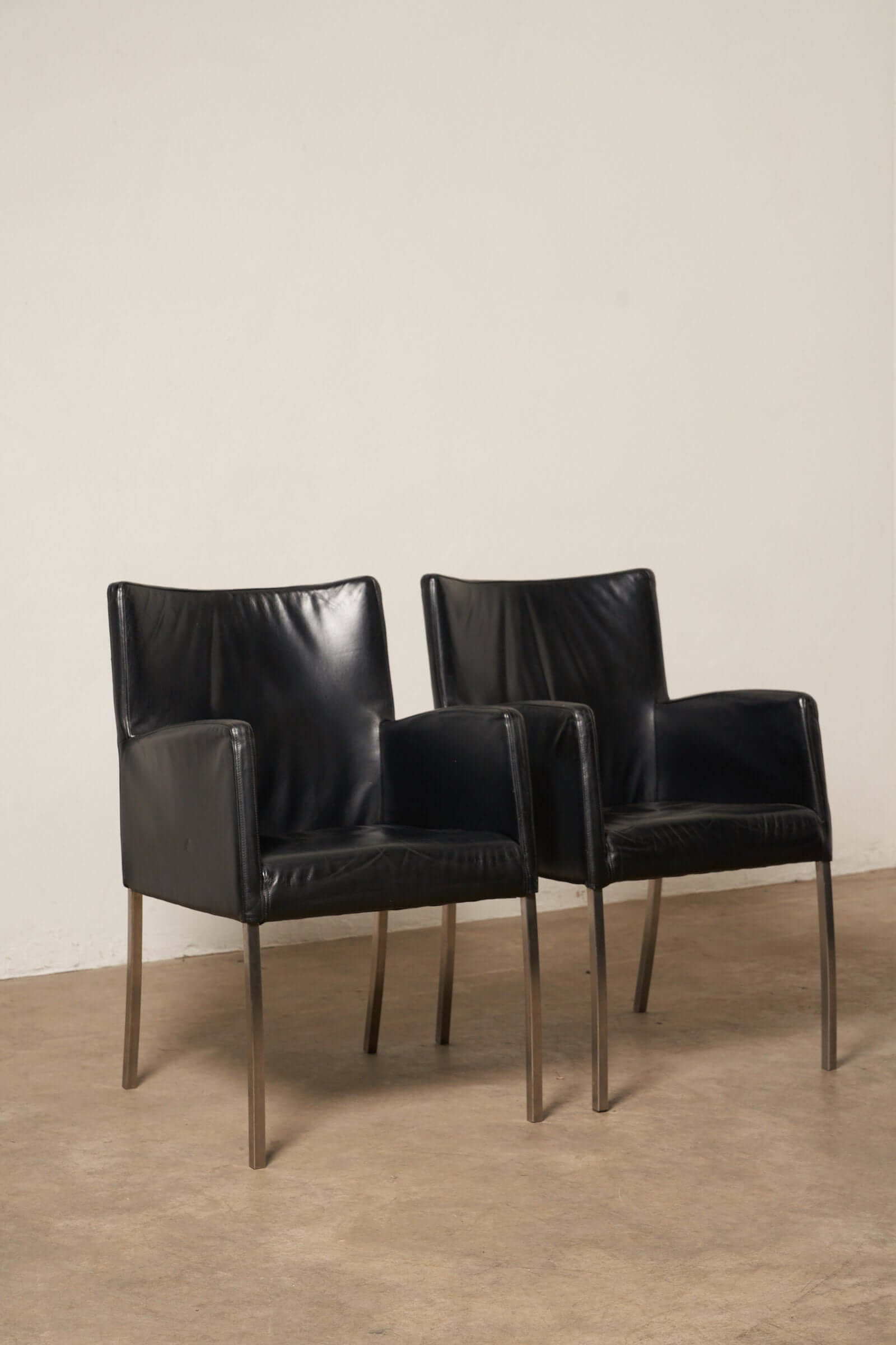 Pair of deep black leather armchairs from the Red or Black Leather Armchairs collection, showcasing high-end Italian design.