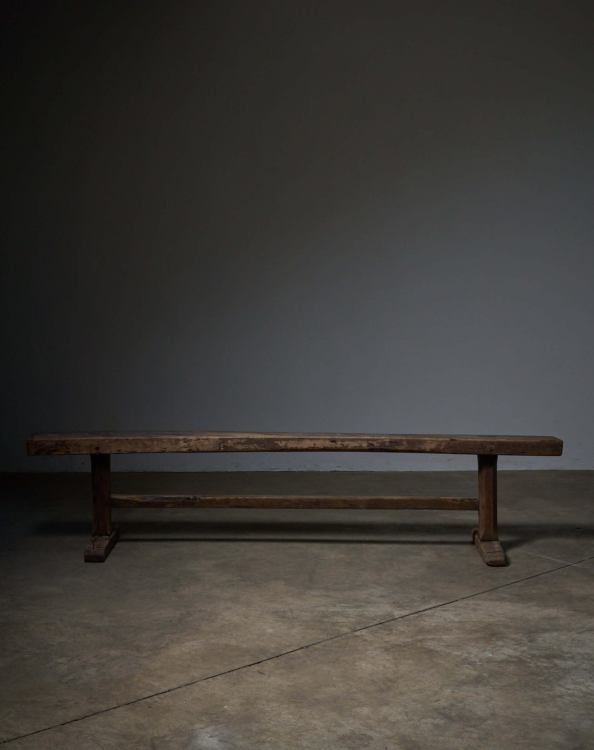 Spanish Trestle Bench in Solid Wood, rustic bench with a thick rectangular top and sturdy T-shaped legs.