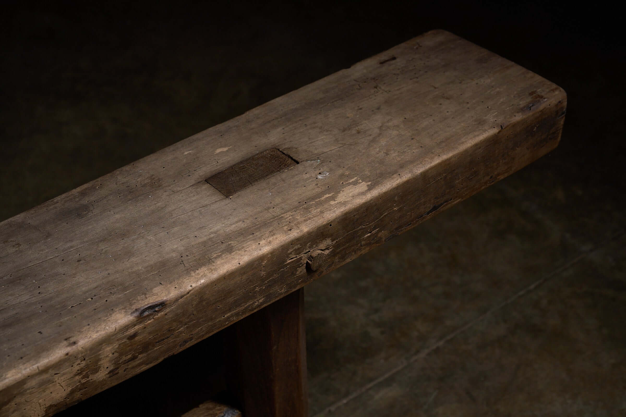 Spanish Trestle Bench in Solid Wood featuring a thick, rustic, single-plank rectangular top with visible joinery details.