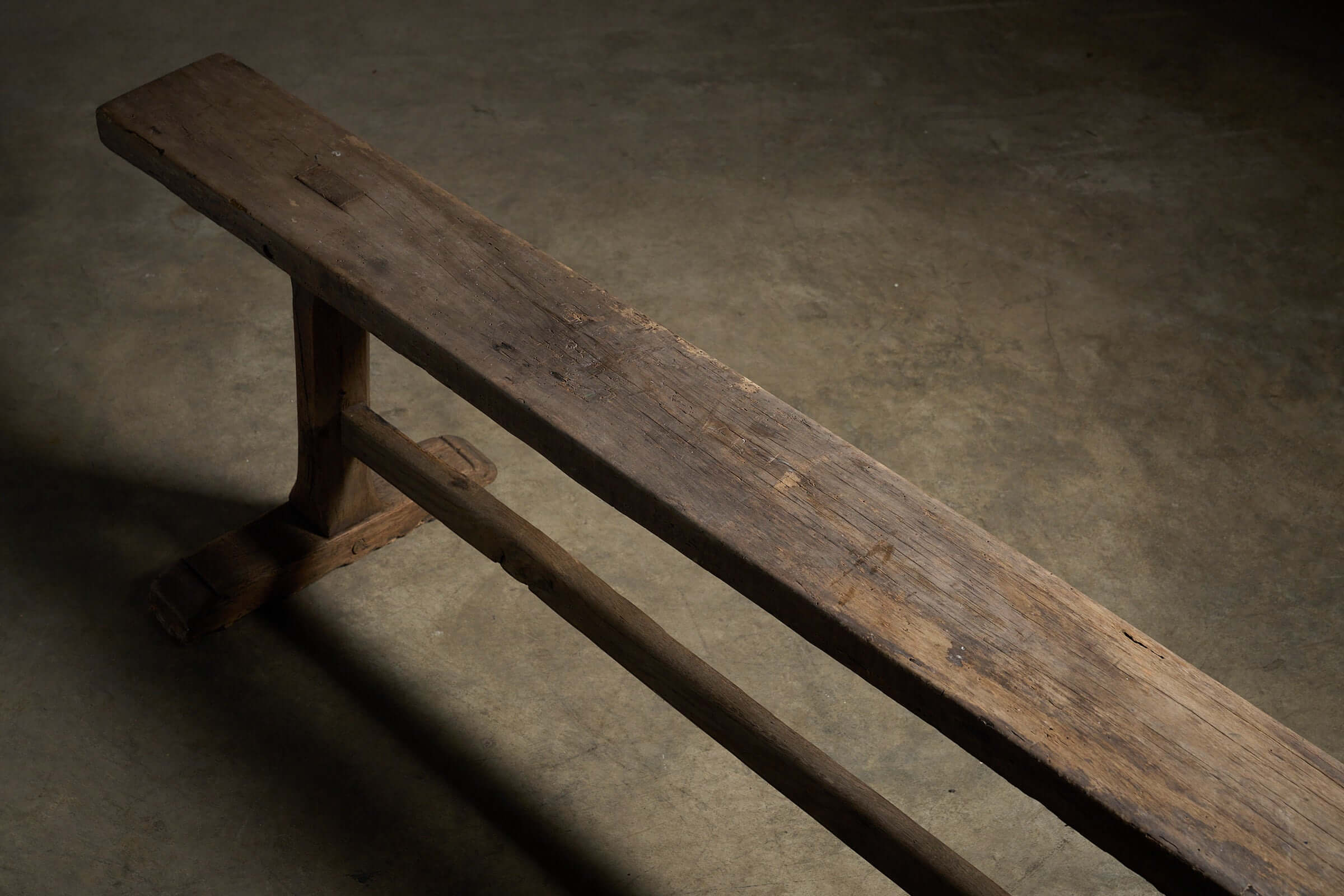 Spanish Trestle Bench in Solid Wood showcasing a rustic solid wood construction with a weathered finish.