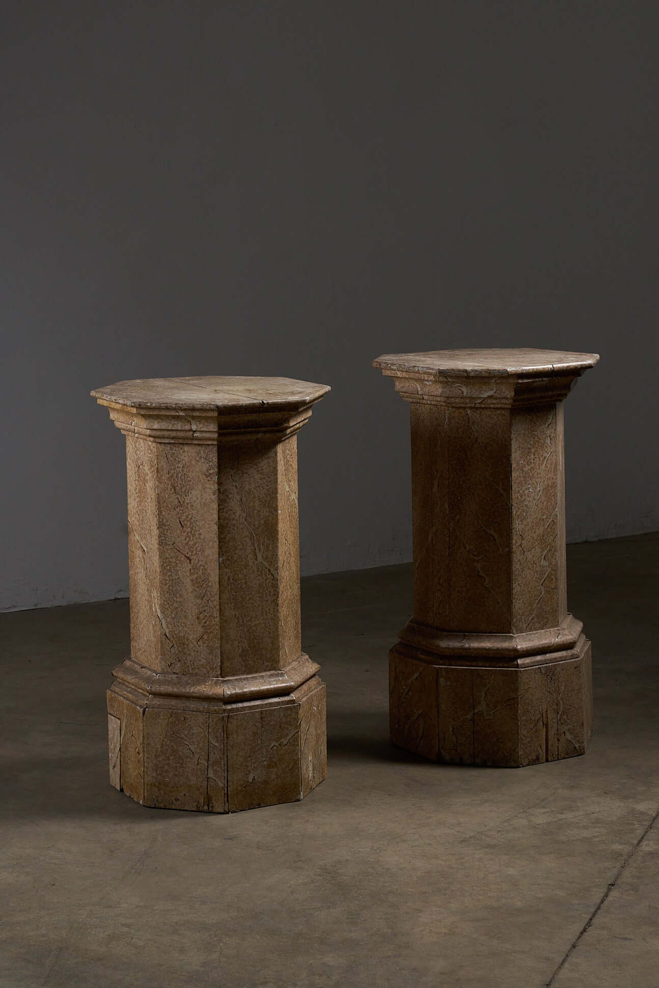 Pair of Antique Faux Marble Octagonal Pedestals showcasing hand-painted faux marbre finish and varying heights.