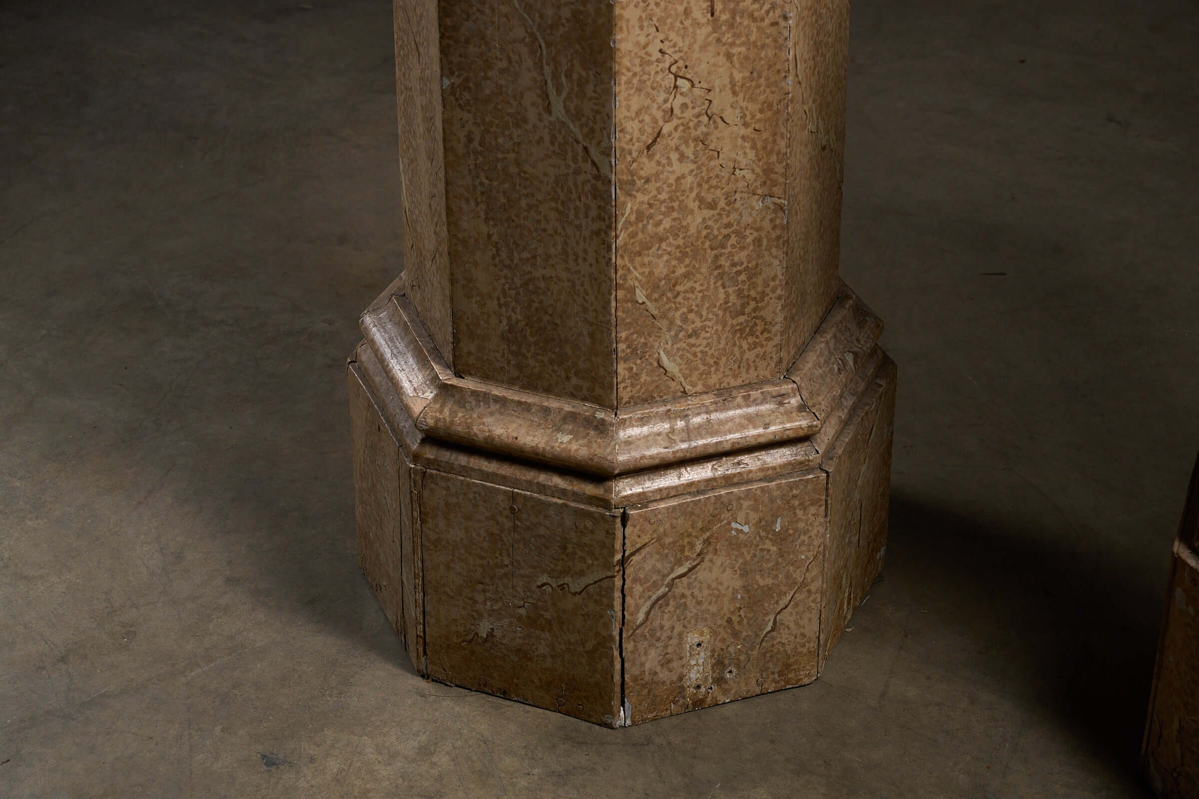 Close-up of the base of a Pair of Antique Faux Marble Octagonal Pedestals, showcasing the faux marbre finish.