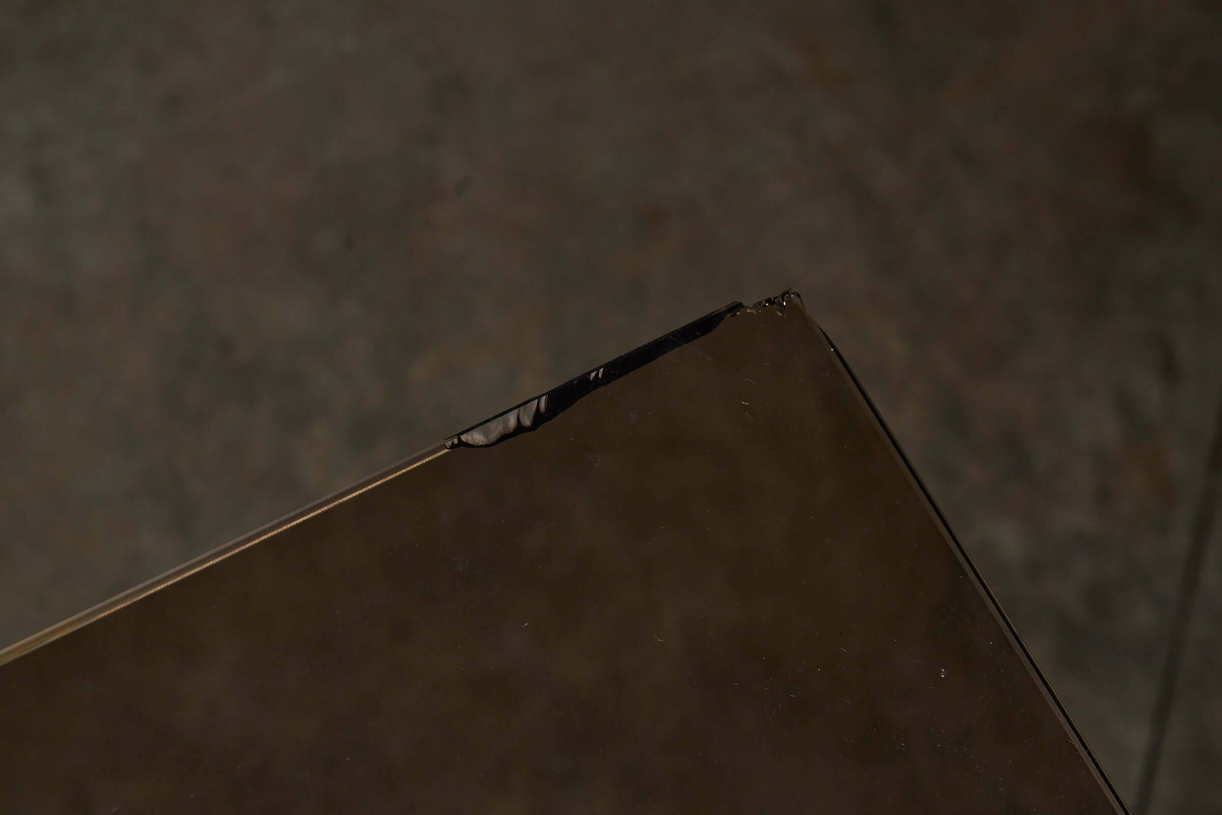 Close-up view of a damaged edge of the Postmodern 'Greek Ruins' Console Table in Mactan Stone 1980s.