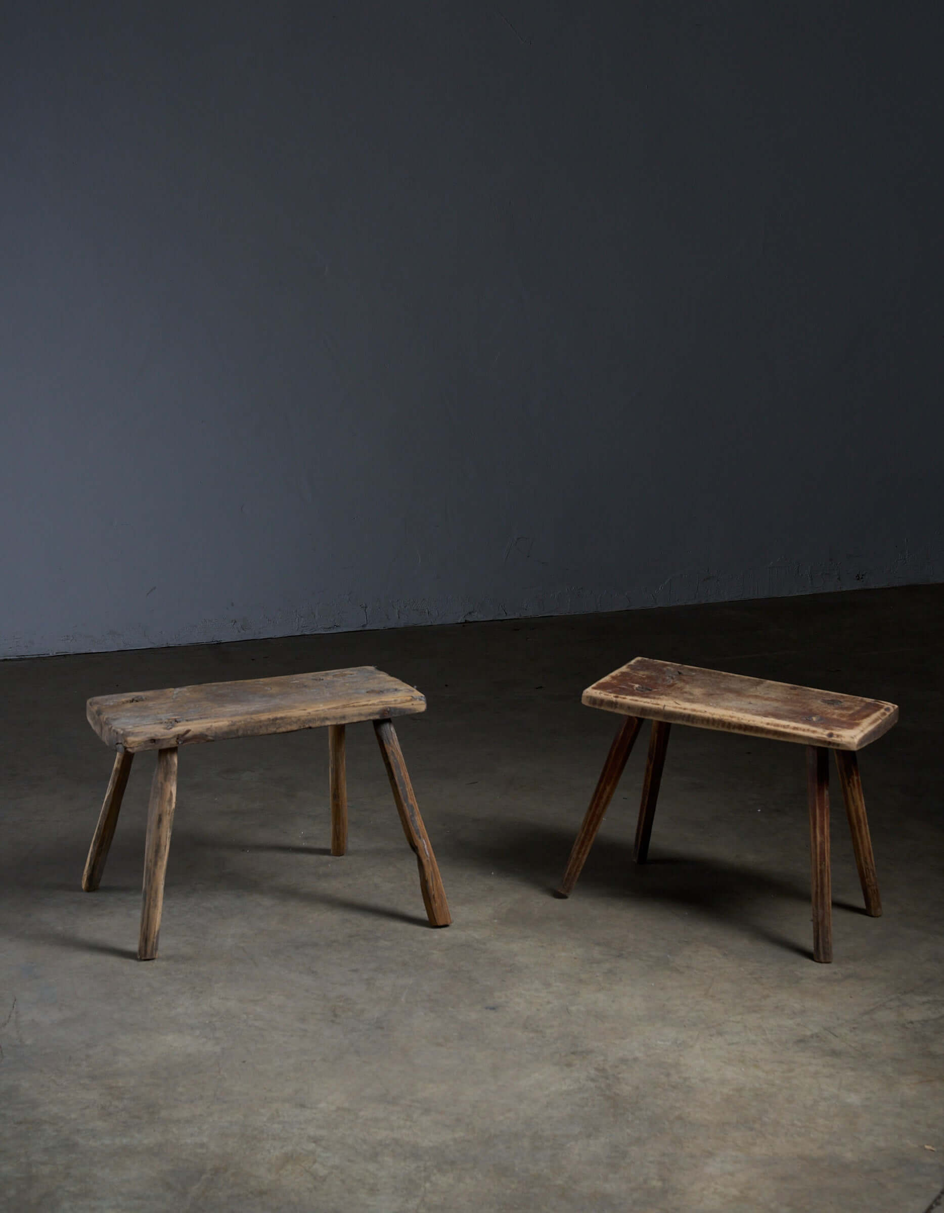 Antique Wooden Stools showcasing distinct shapes and textures, perfect as low side tables or plant stands.