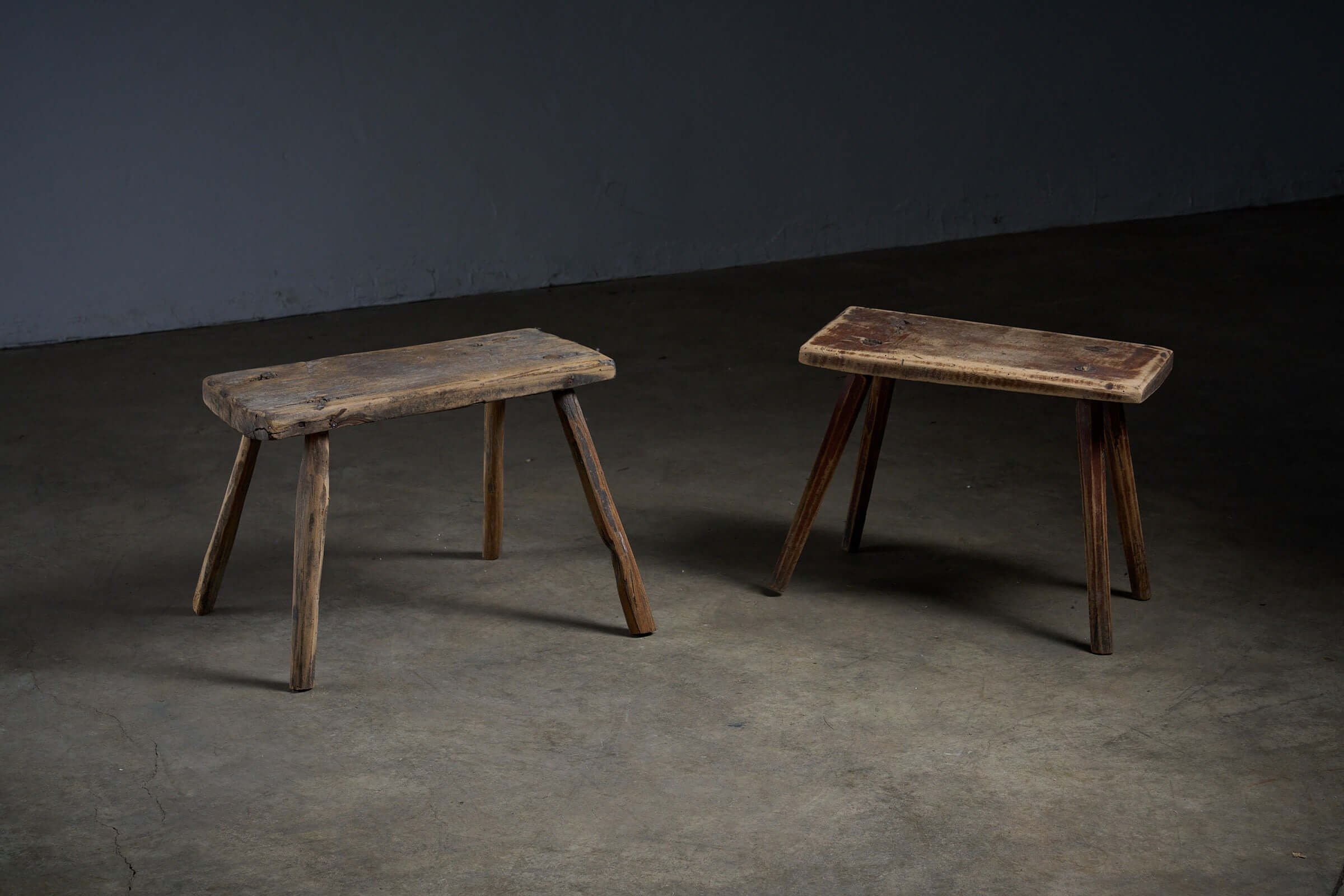 Antique Wooden Stools - set of two with textured surfaces and historic marks, perfect as low side tables.