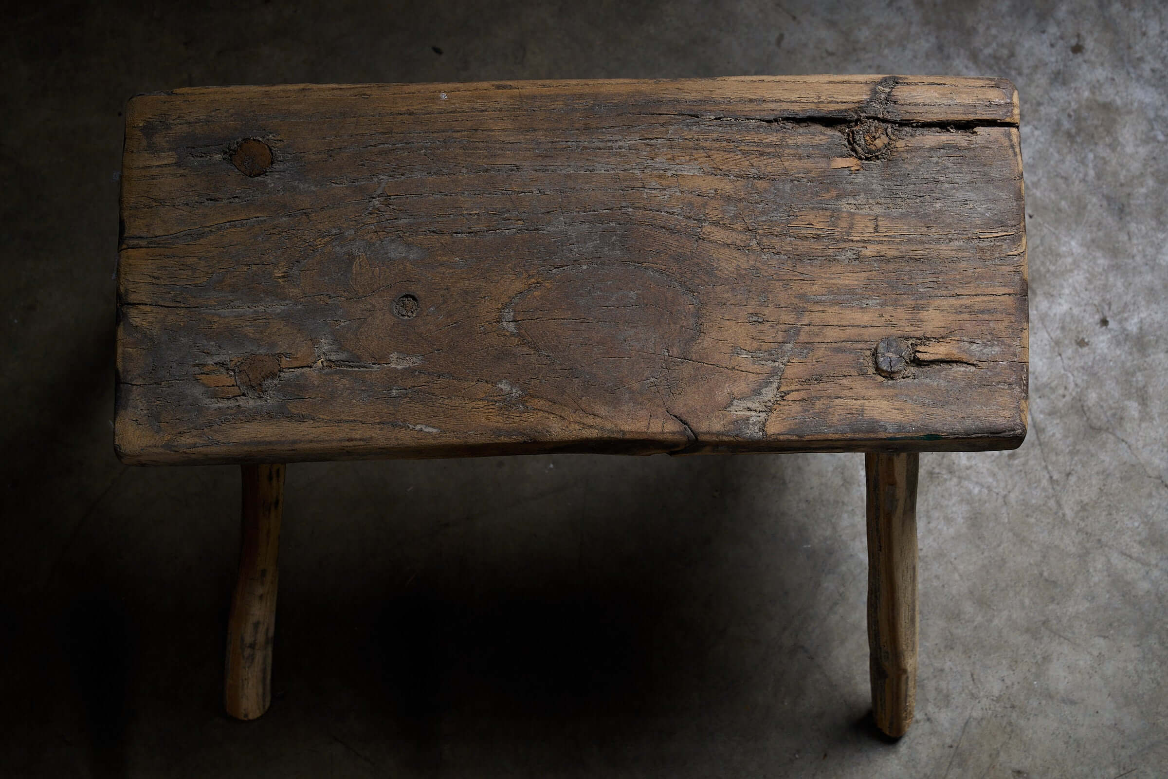 Antique Wooden Stools with textured wood surface and historic marks, perfect as low side tables.