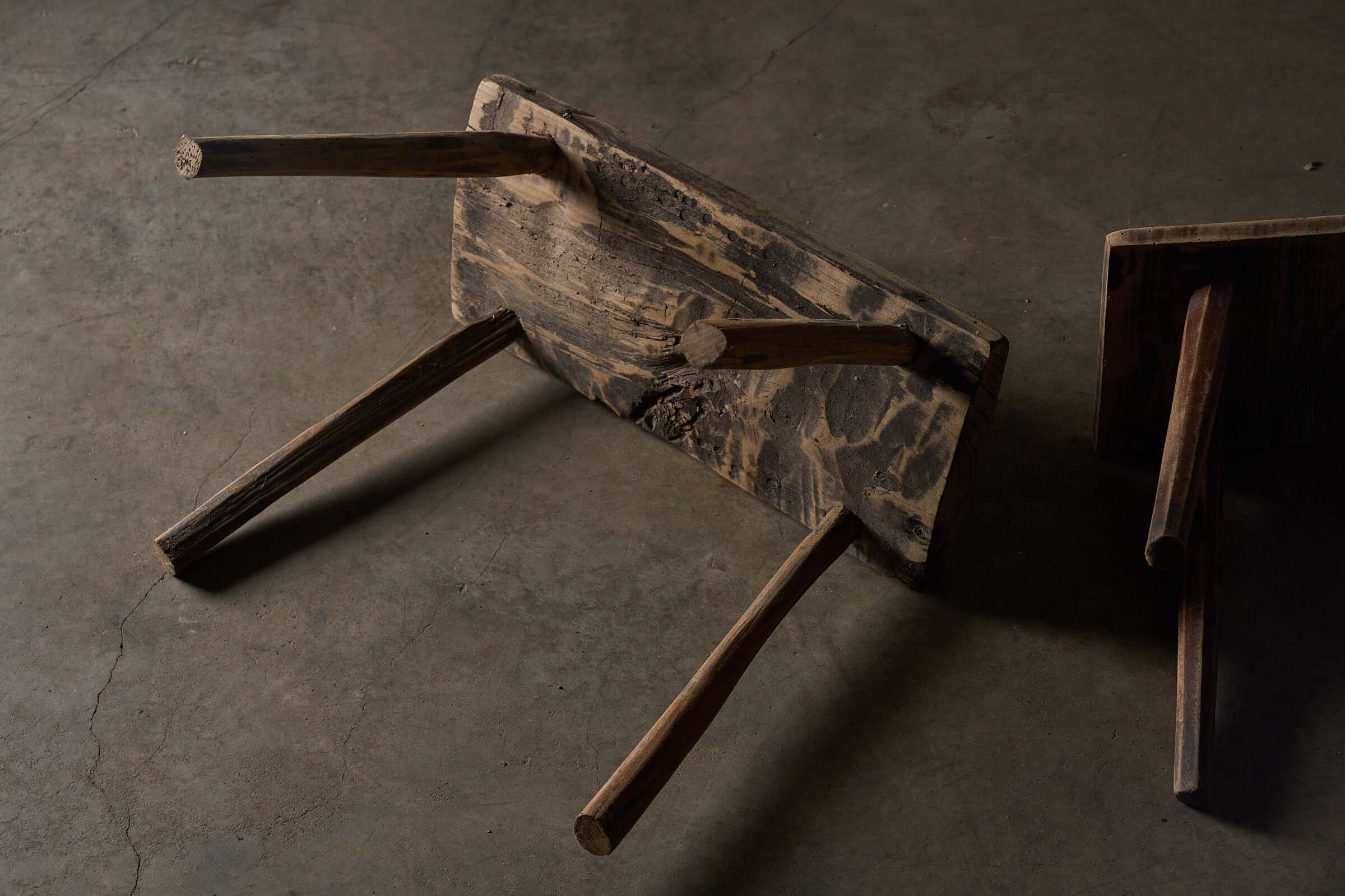 Antique Wooden Stools showcasing heavily textured wood surfaces and unique structures in a stylish arrangement.