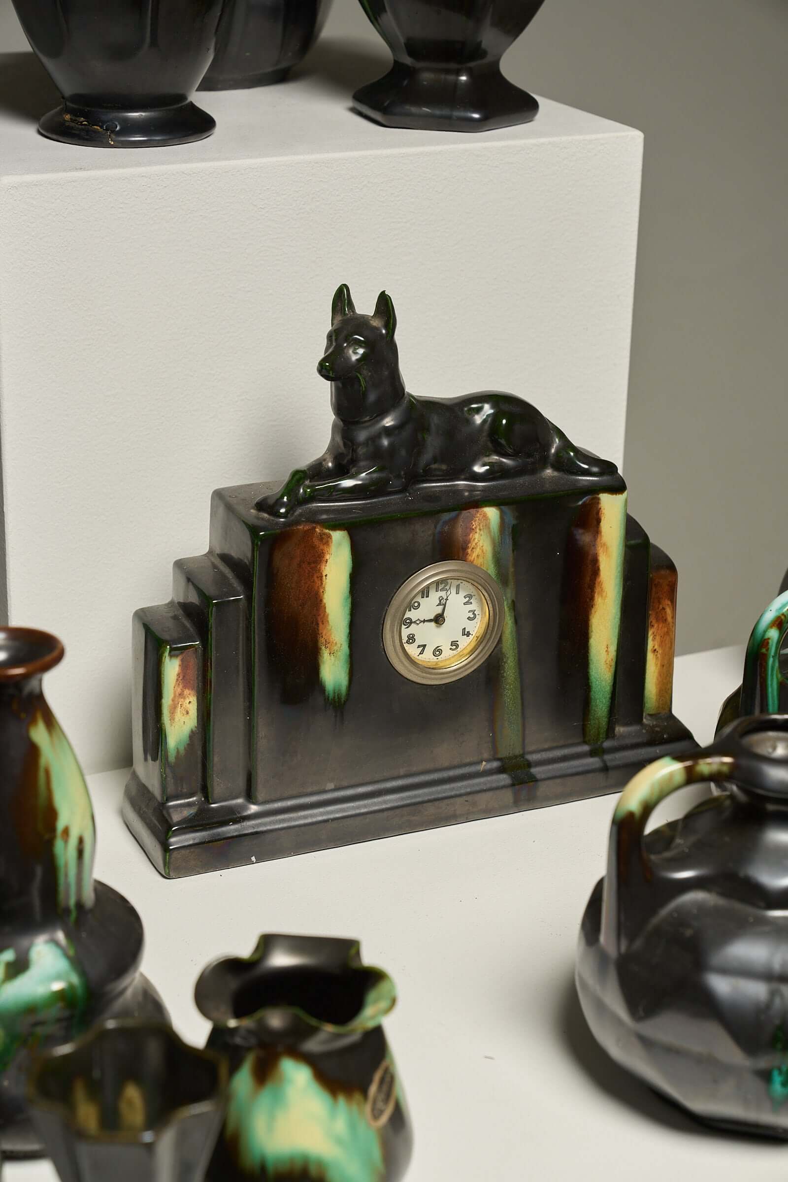 Large Collection of Belgian Art Deco Drip Glaze Ceramics 1920s featuring a mantel clock and various ceramic pieces.