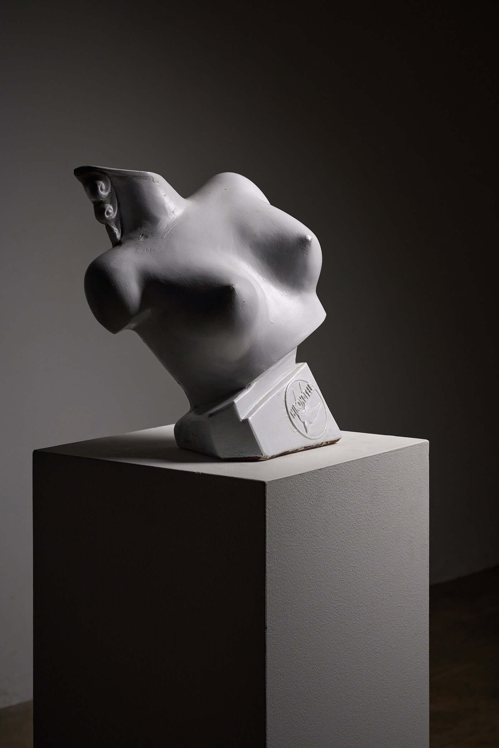 Mid-Century Plaster Display Busts by Hirondelle on a pedestal against a dark background.