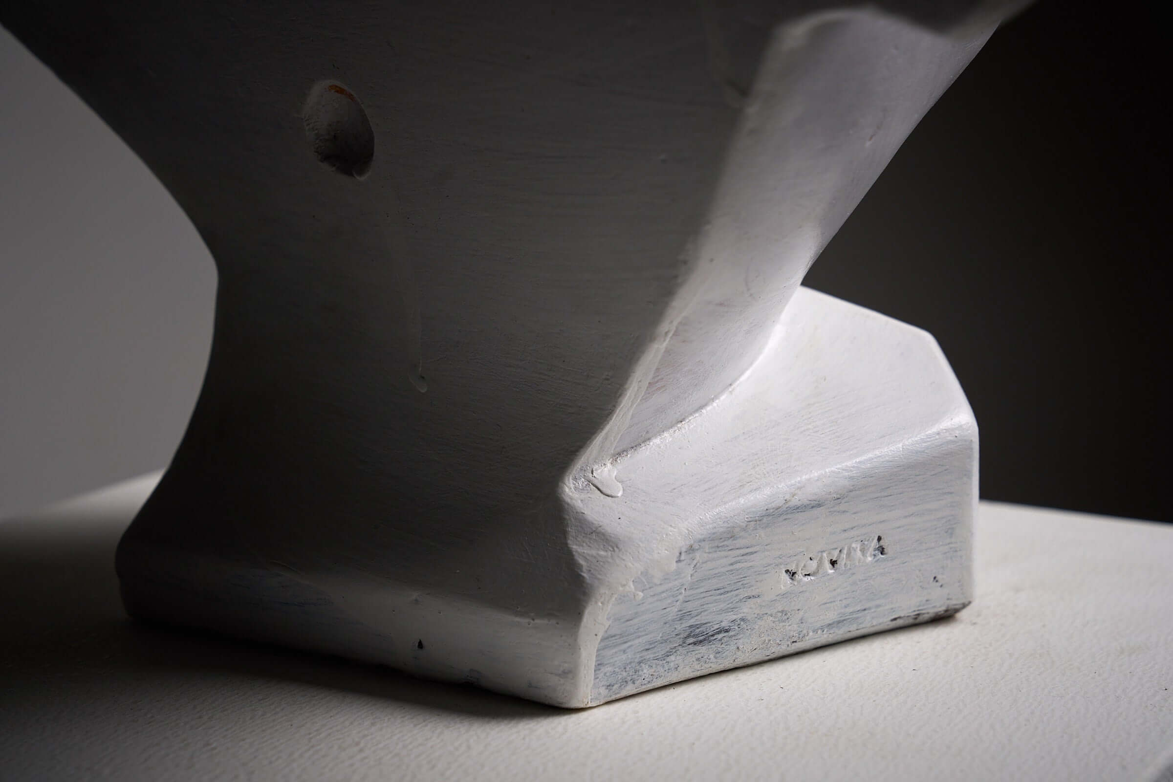 Close-up of base marking on Mid-Century Plaster Display Busts by Hirondelle sculpture.