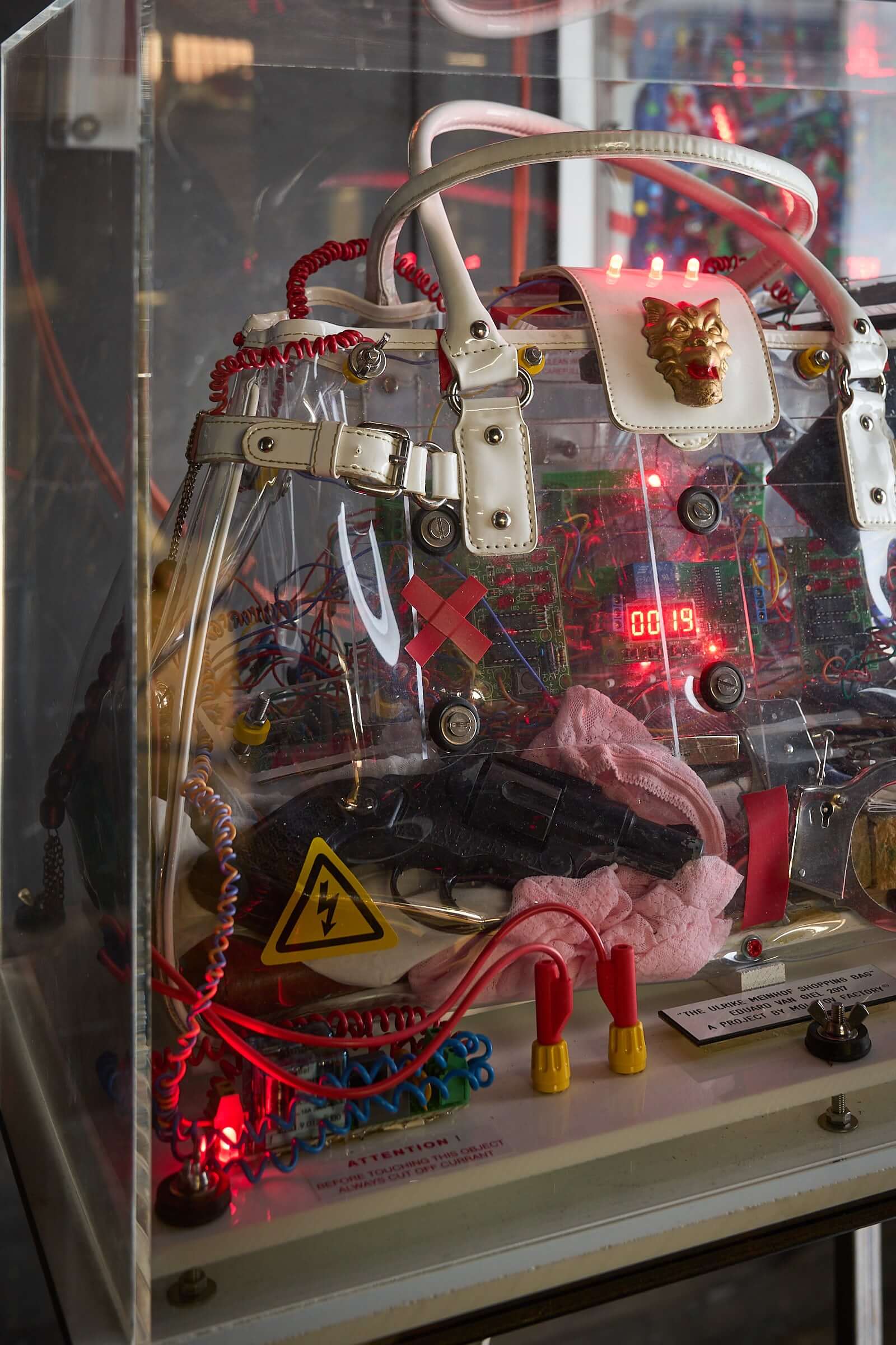 The Ulrike Meinhof Shopping Bag Installation by Eduard Van Giel (2017) mixed-media sculpture with acrylic vitrine.