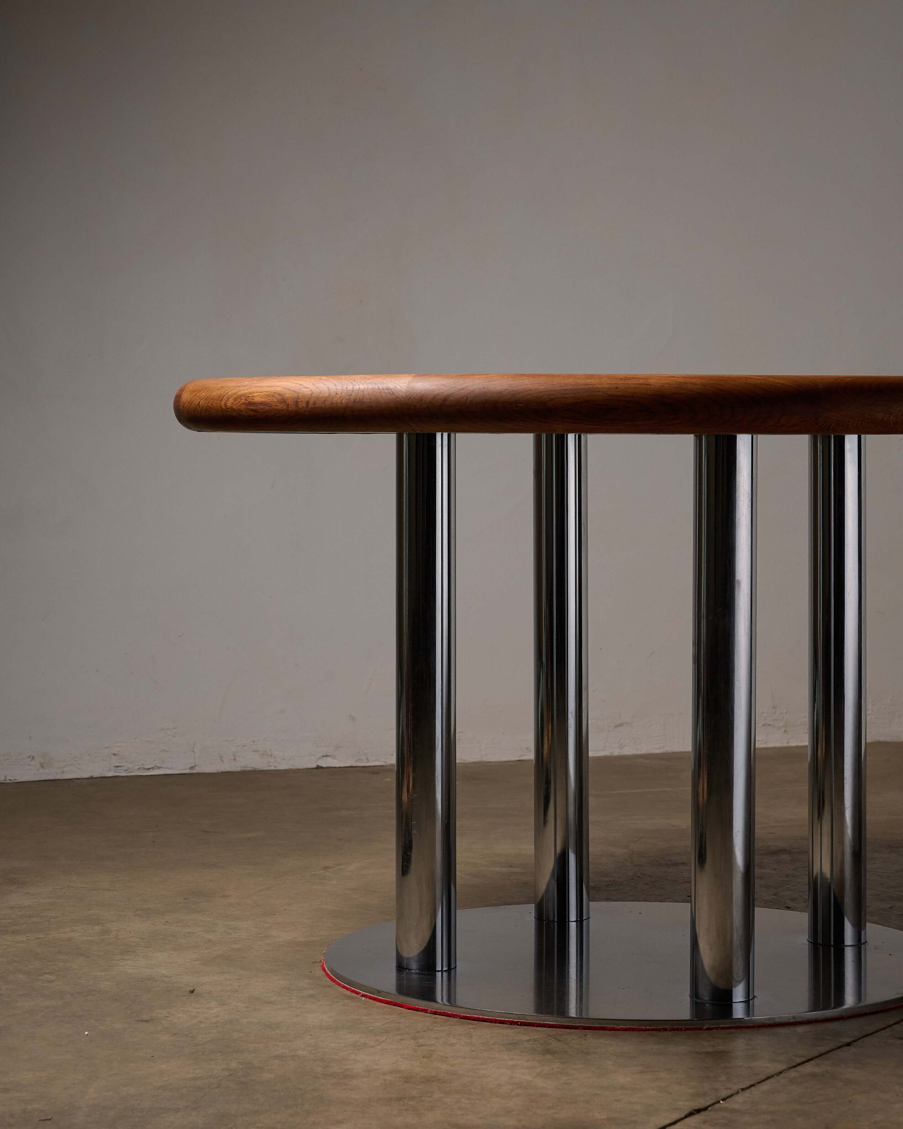 Round 1970s Dining Table with Chrome Pillar Base showcasing chrome-plated cylinders and a wooden top.