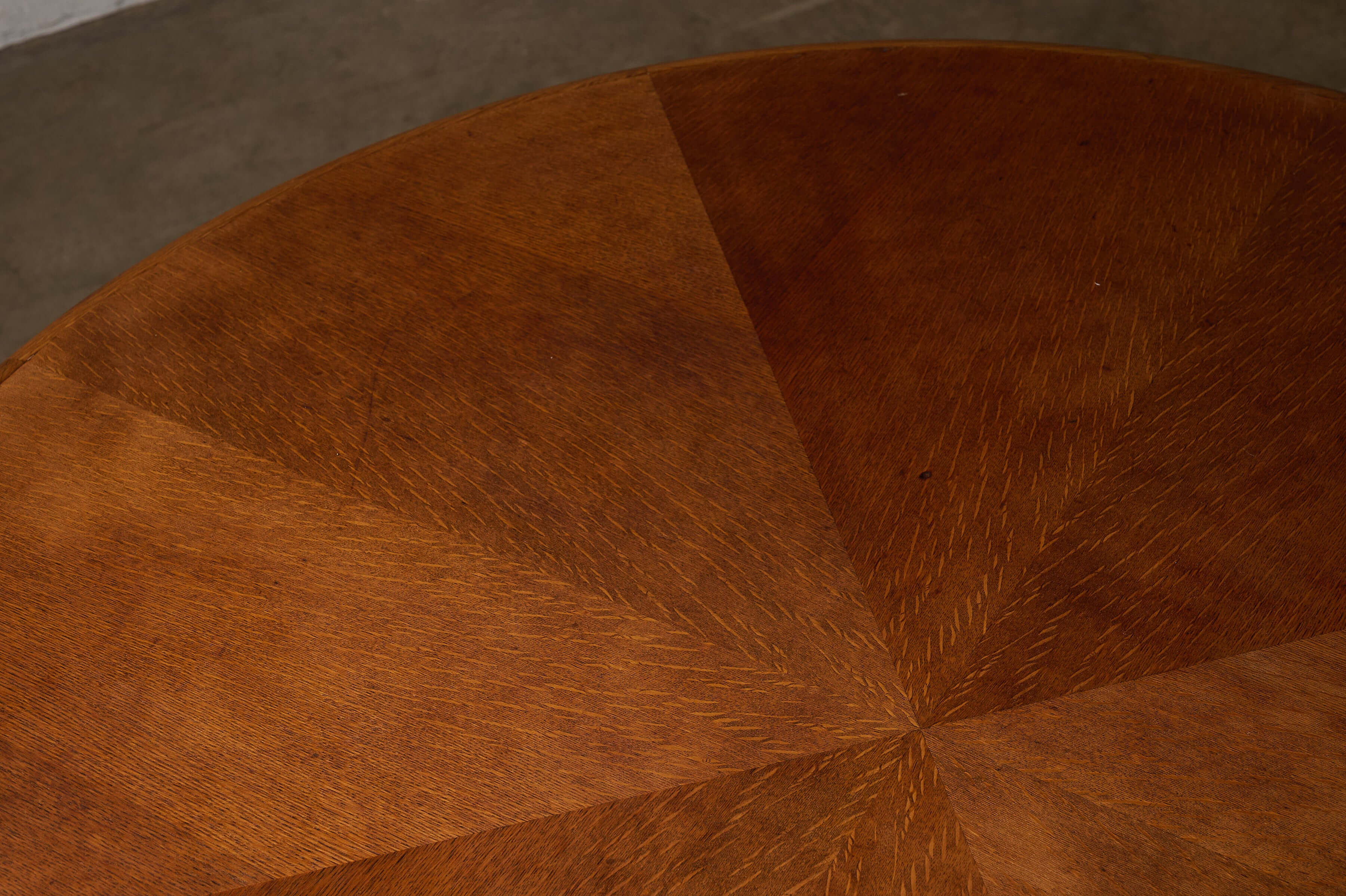 Close-up of the surface of a Round 1970s Dining Table with Chrome Pillar Base, showcasing its warm wood finish.